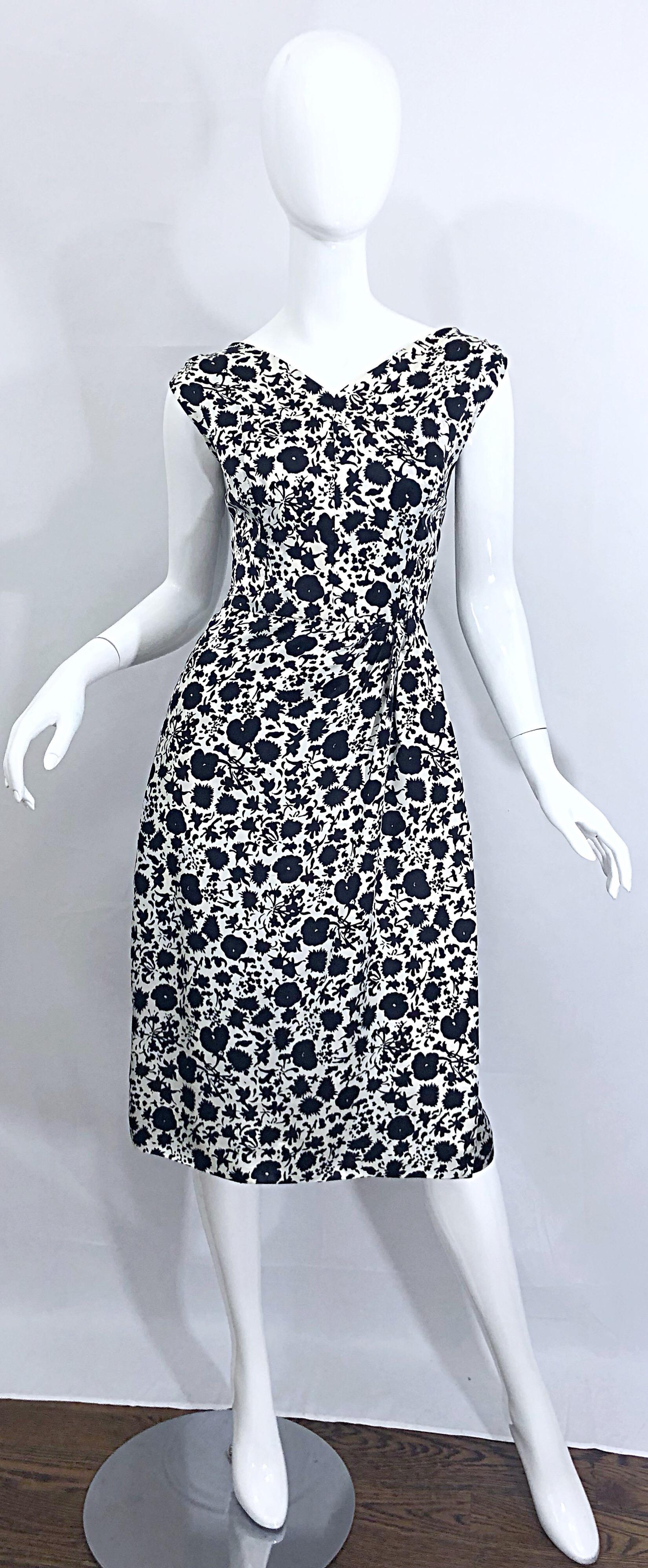 Gorgeous 1950s demi couture HOUSE OF BRANELL black and white floral print silk short sleeve dress! Faux wrap style is flattering and comfortable for an array of sizes. Fitted bodice with a forgivinging skirt. Full metal zipper up the back with