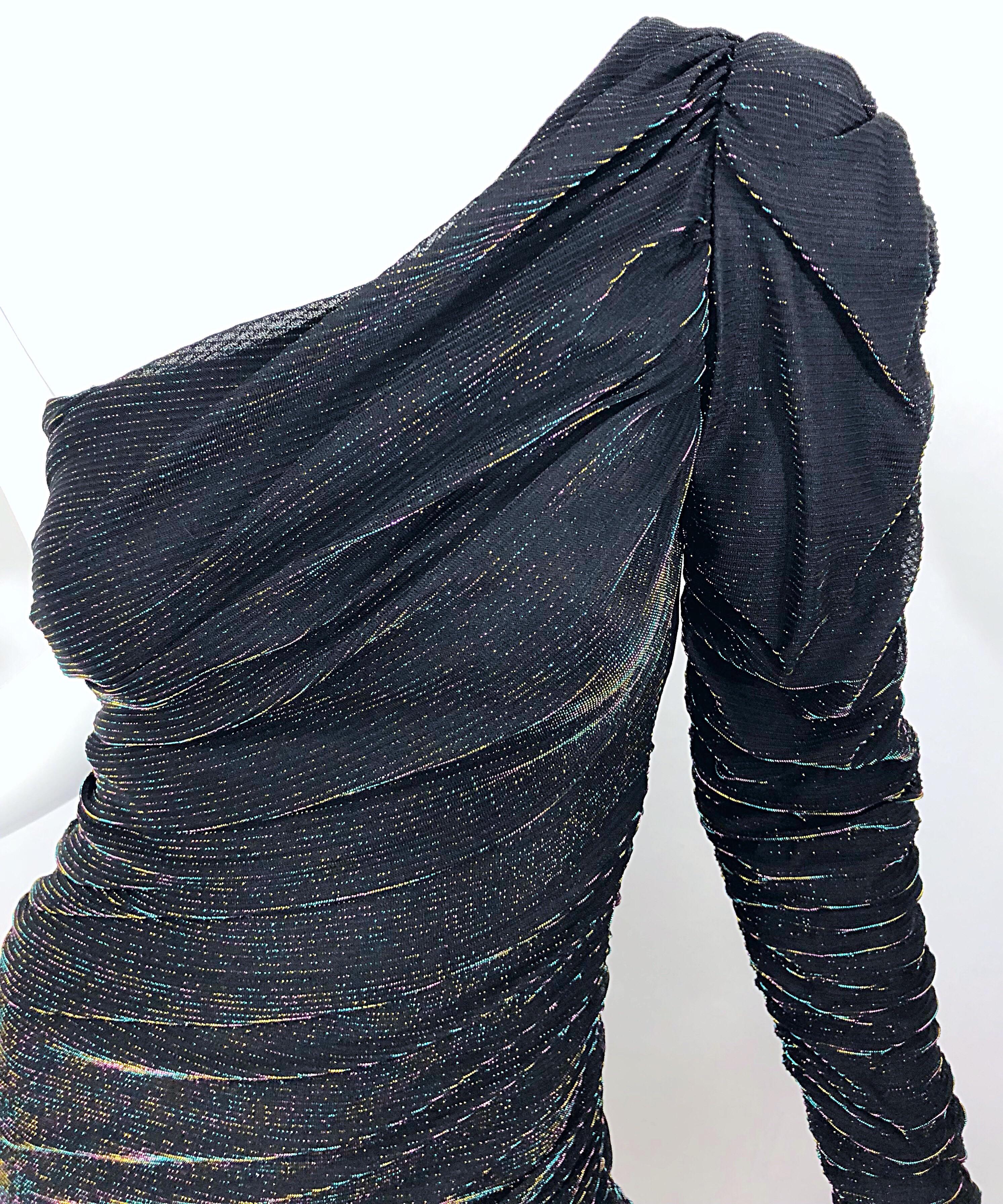 Beuatiful 1980s SAMIR black metallic rainbow one shoulder cocktail dress! Features flattering and forgiving ruching throughout. Black backdrop with a colorful rainbow metallic sheen. Mermaid hem. Hidden zipper up the side with 
hook-and-eye closure.