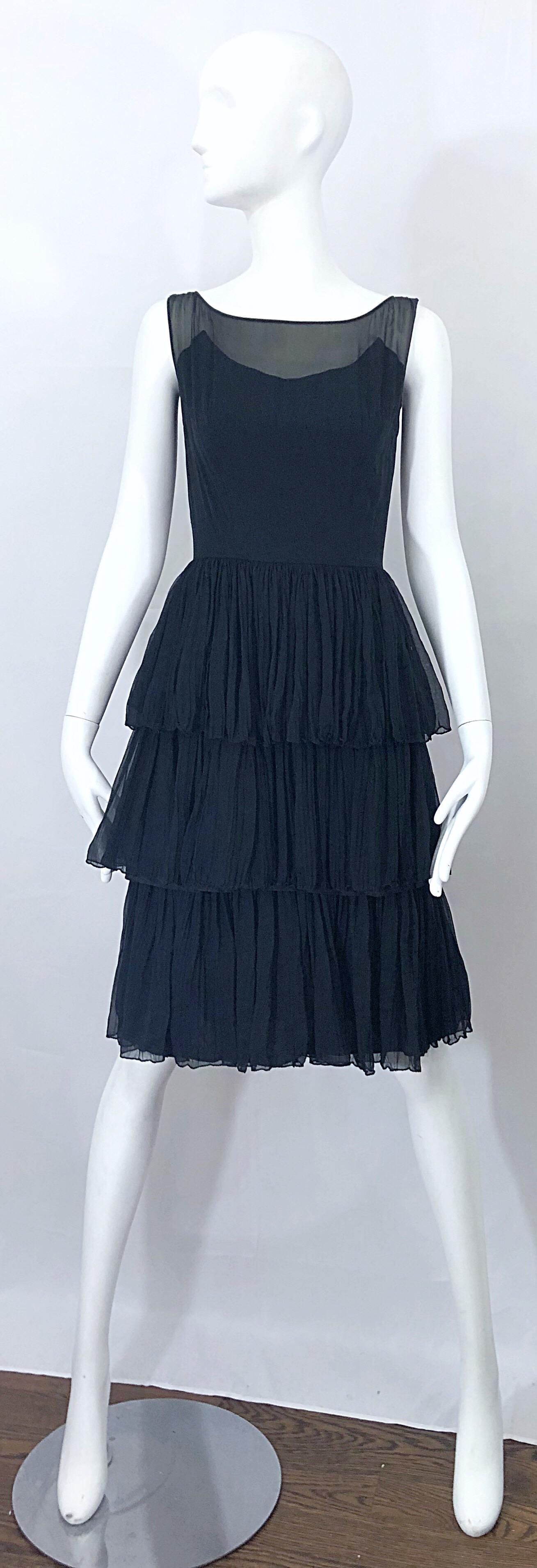 Incredible 1950s SUZY PERETTE black silk chiffon nude illusion couture tiered cocktail dress! Features a black strapless bodice with a sheer chiffon overlay. Three tiers of soft luxurious chiffon. Full metal zipper up the back with hook-and-eye