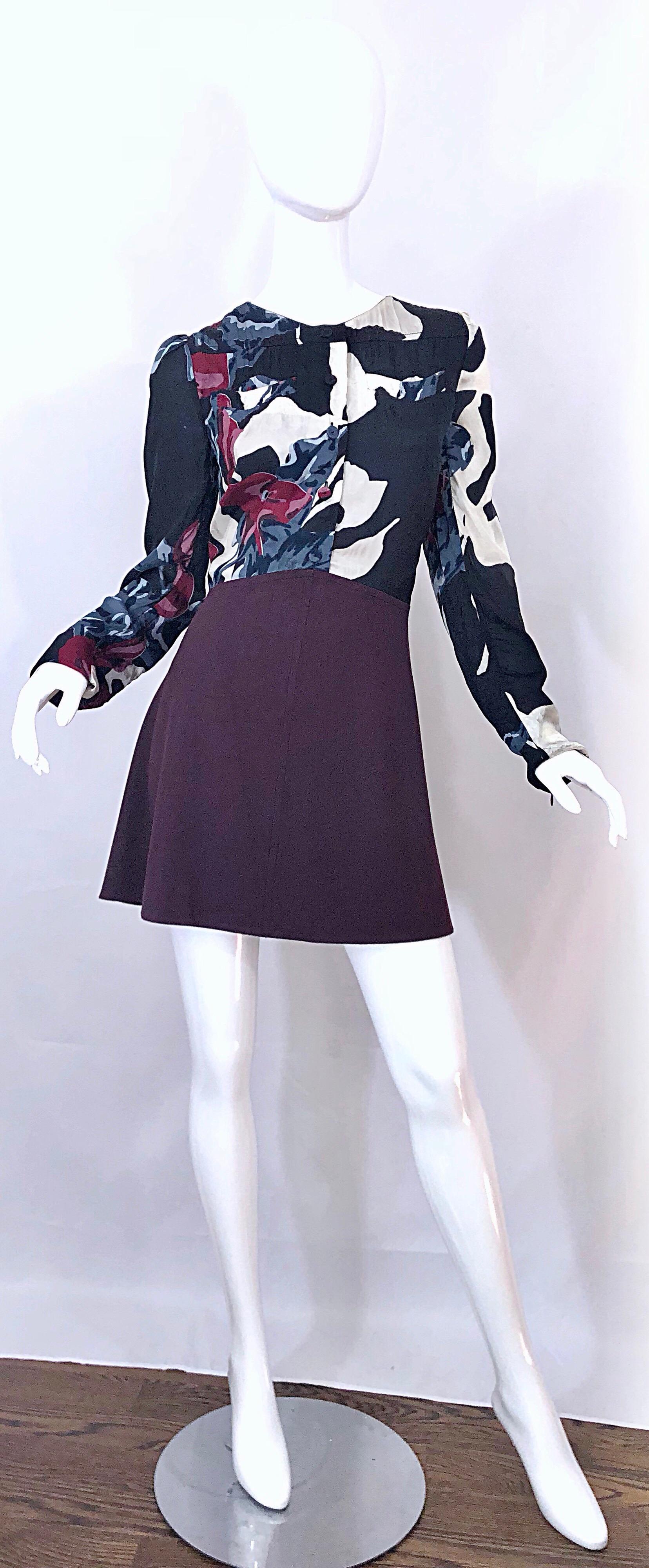 This never worn CARVEN Fall 2009 mini dress is from one of the French brand's 'revival' era in 2008. Features a rayon / viscose bodice with abstract prints in burgundy maroon, blue, black and white. Long sleeves with mock buttons up the front.