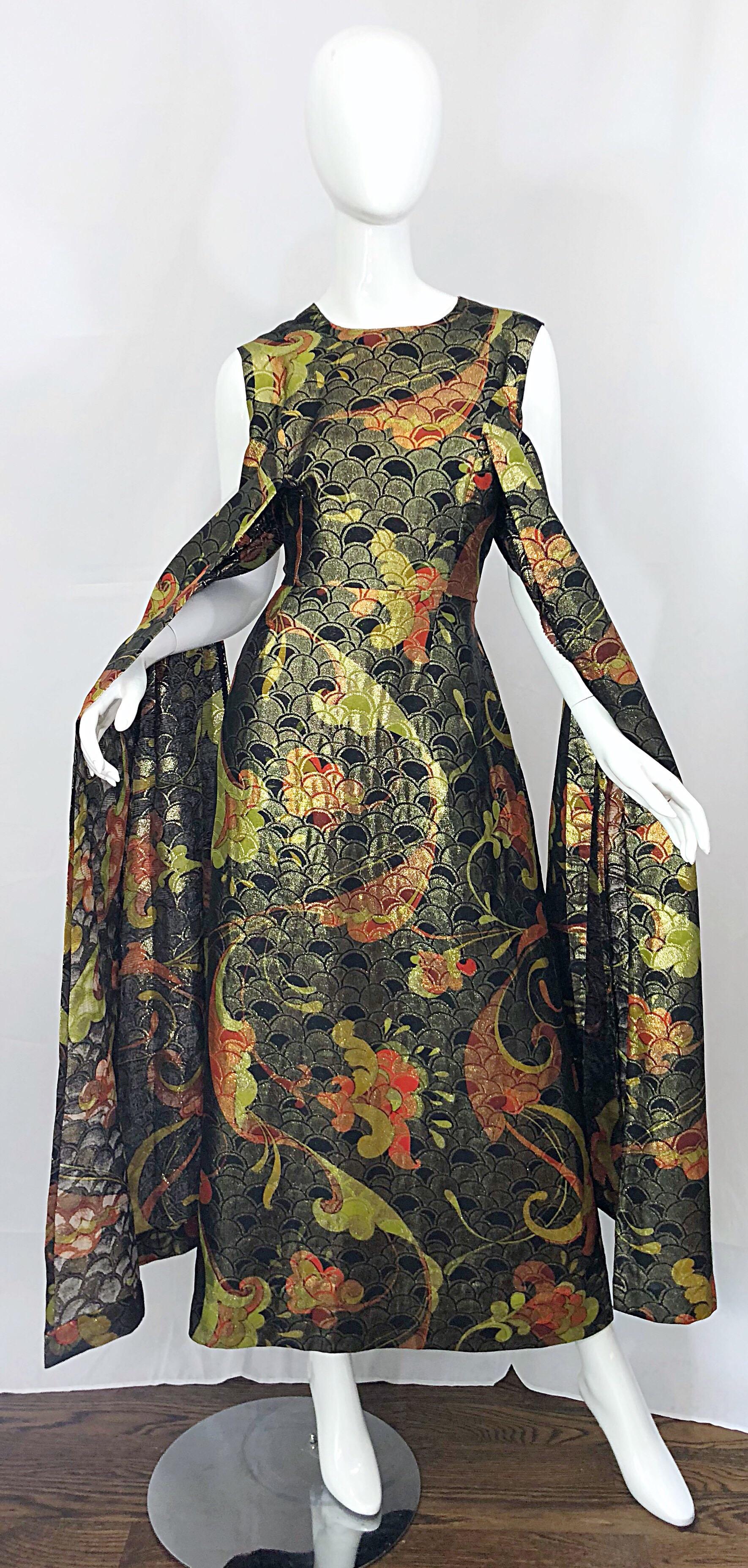 Incredible 1960s couture grade Asian print silk metallic maxi dress! Features Asian themed prints in warm tones of chartreuse green, olive green, rust, red, and black throughout. Fabulous 'wings' in the fron can be worn around the arms for a more