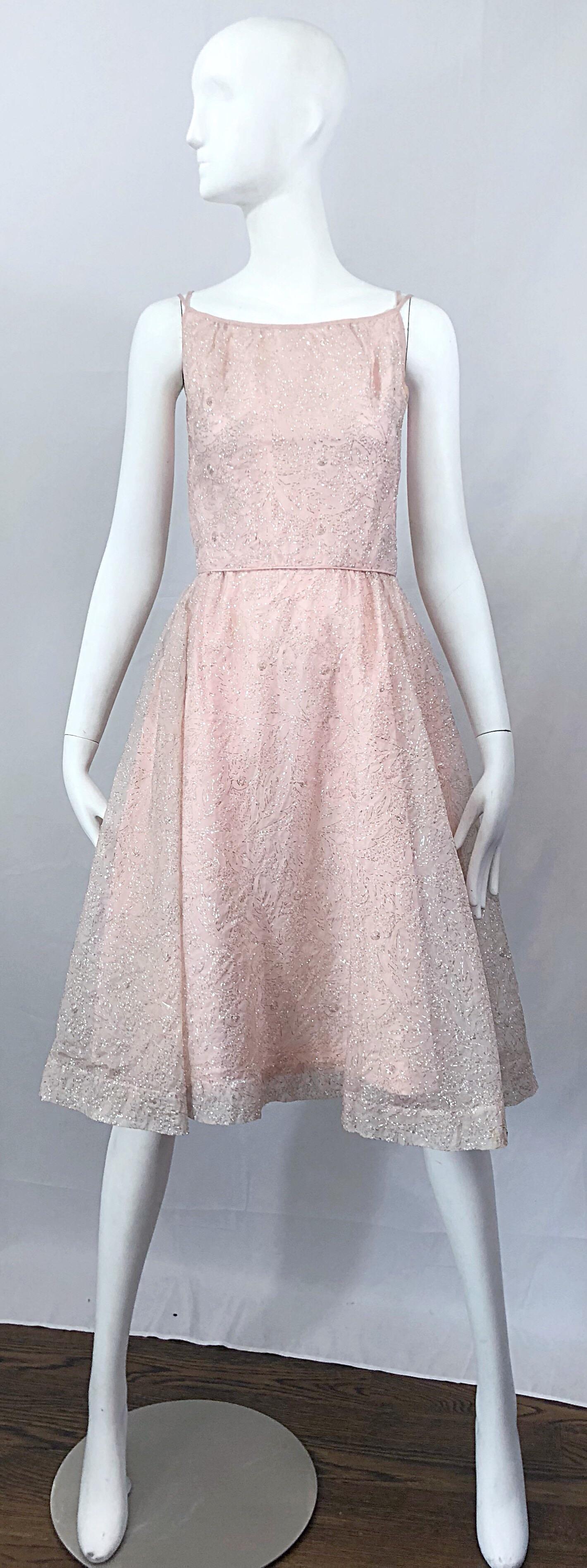 Beautiful vintage 50s CARYLE light pale pink and silver silk taffeta fit n' flare cocktail dress and lightweight metallic lurex cropped bolero jacket! Dress features a fitted bodice with a forgiving flared skirt. Taffeta underlay with a semi sheer