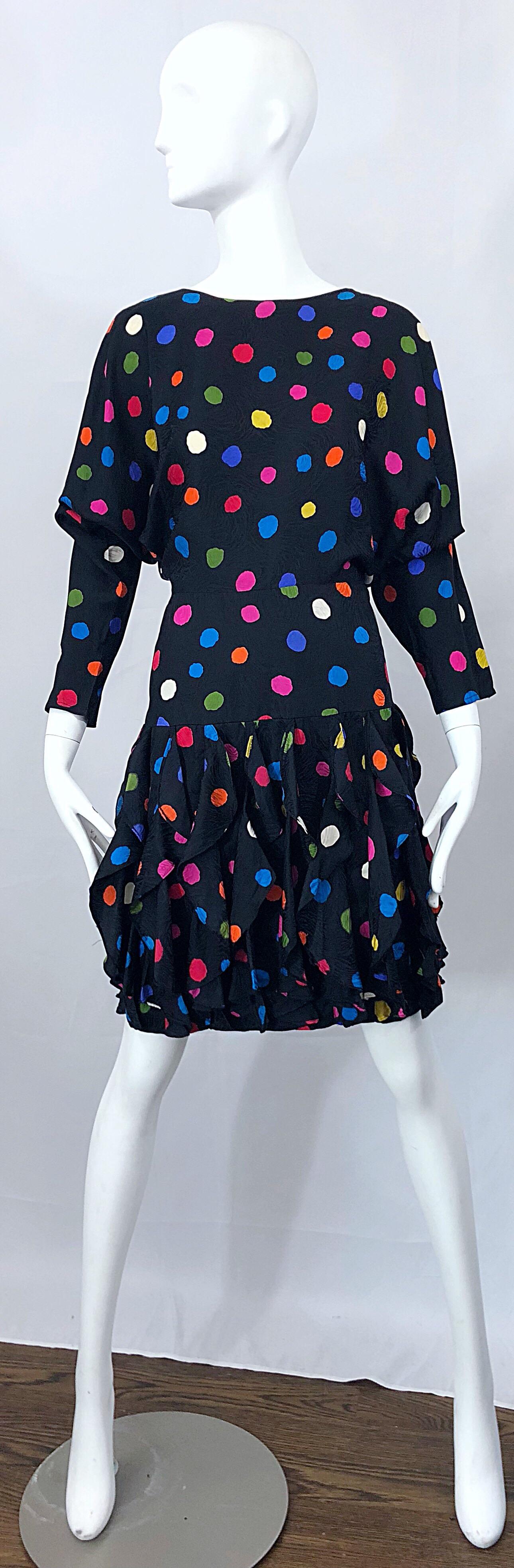 Amazing vintage Avant Garde black silk colorful polka dot flutter skirt dress! Features awesome dolman sleeves with tapered arms. Slight drop waist with flutter skirt that looks amazing on, especially on the dance floor. Hidden zipper up the back