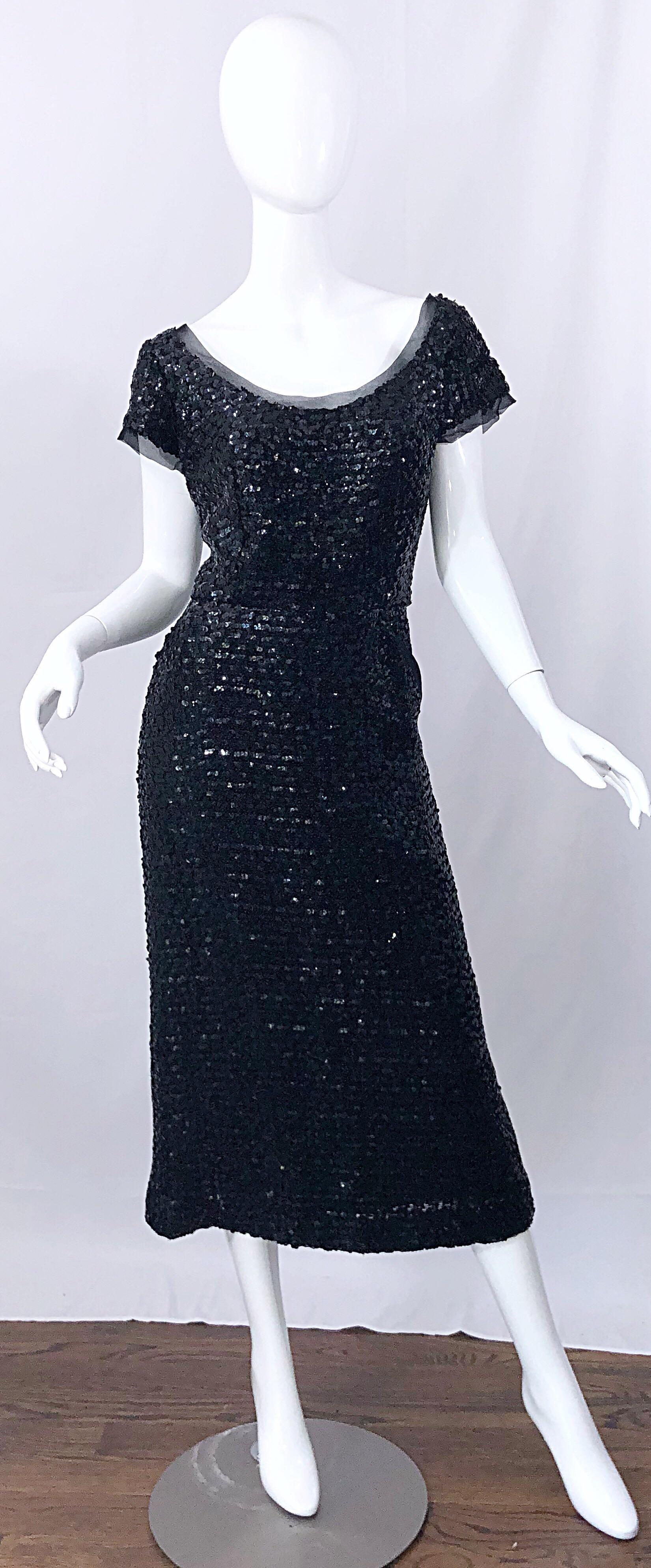Stunning vintage 50s Bullock's Wilshire demi couture black silk sequined tea length midi dress! Features thousands of hand-sewn black sequins throughout the entire dress. Pocket at the left side of the hip. Black sheer mesh detail around the