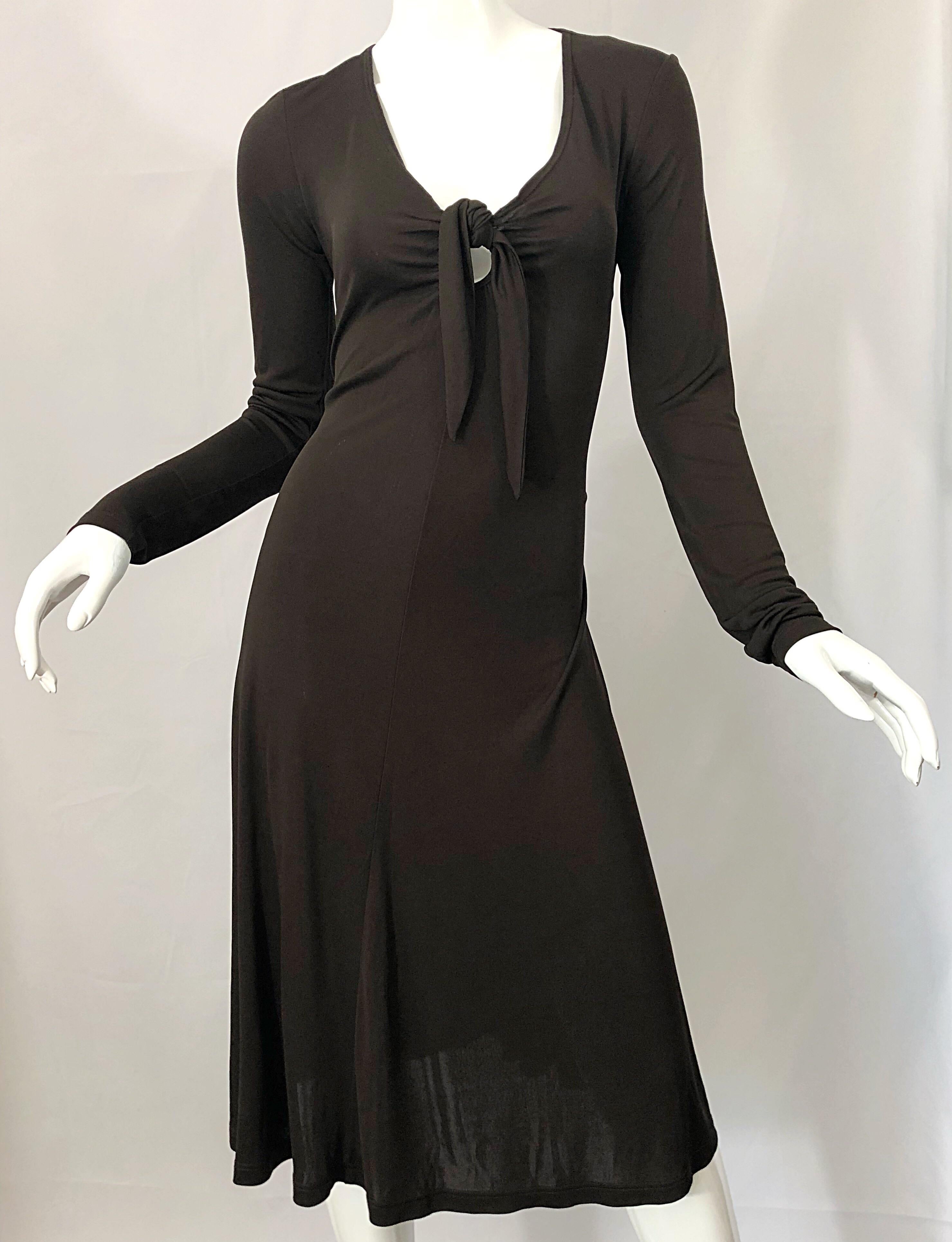 Effortlessly chic MICHAEL KORS COLLECTION brown rayon jersey long sleeve keyhole dress! Features Kors' signature soft jersey that stretches to fit, and really flatters the body. Tailored bodice with sleek long sleeves. Peek-a-boo keyhole ties at