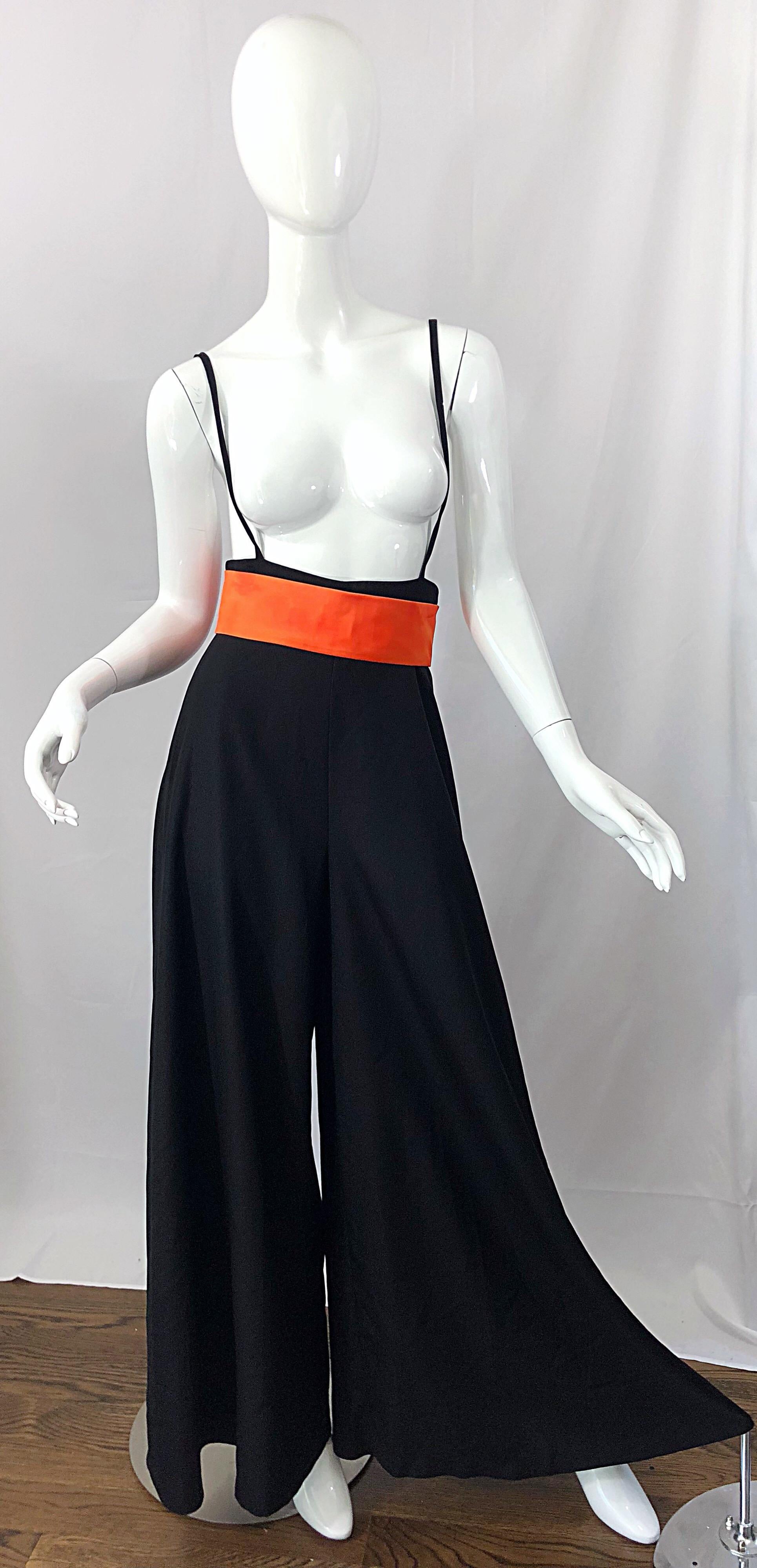 Rare 1970s LILLI DIAMOND black and orange high waisted wide leg suspender palazzo pants! Soft knit fabric stretches to fit. Hidden zipper up the back with hook-and-eye closure. Attached suspenders and the attached bright orange belt add the perfect