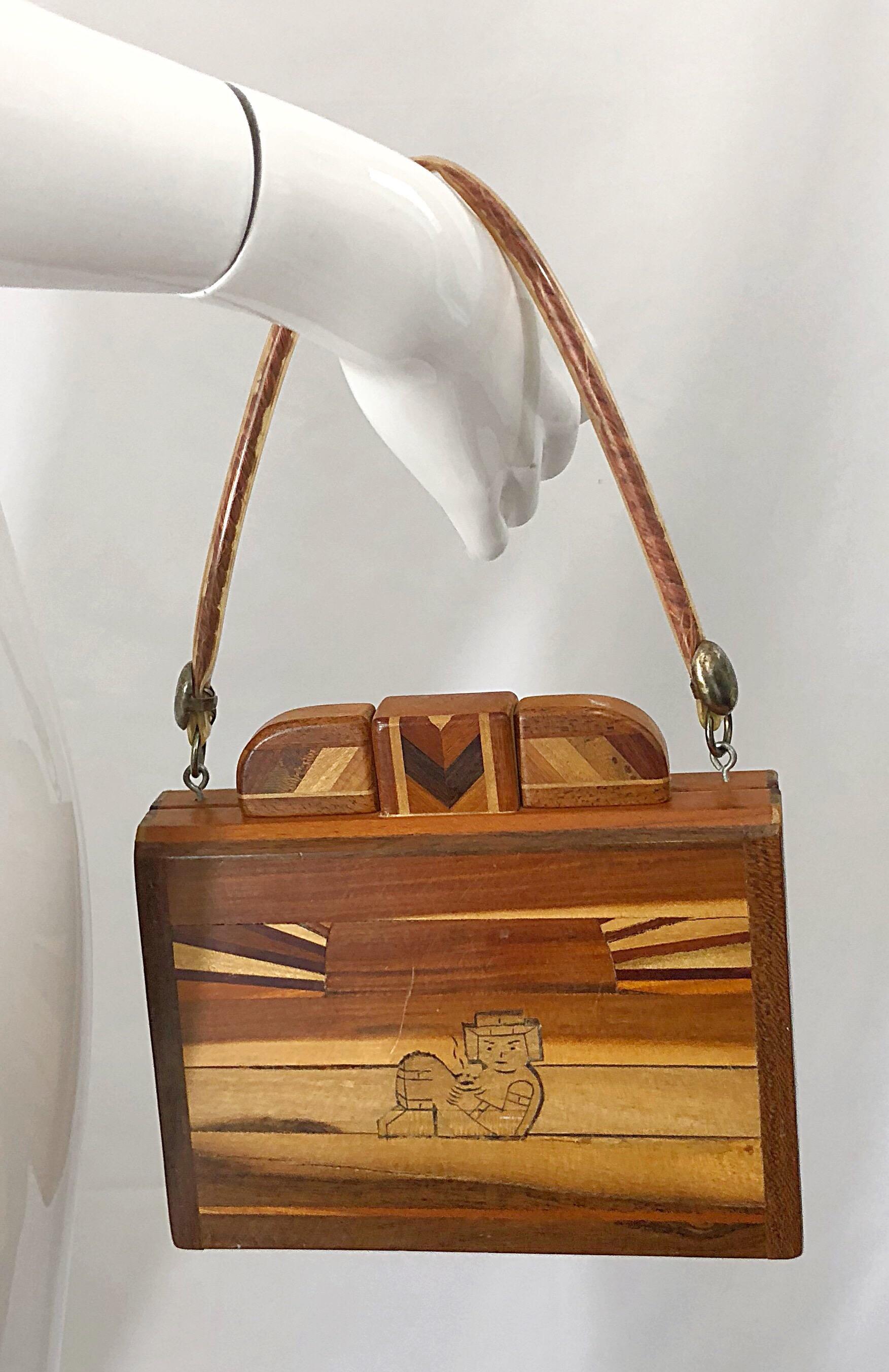 Chic 1960 wooden patchwork novelty bag of various shades on one side, and an Egyptian figure on the other side. Plastic covered handle. The perfect size that fits all the essentials (smartphone, makeup, wallet, etc.) In good condition, with minor