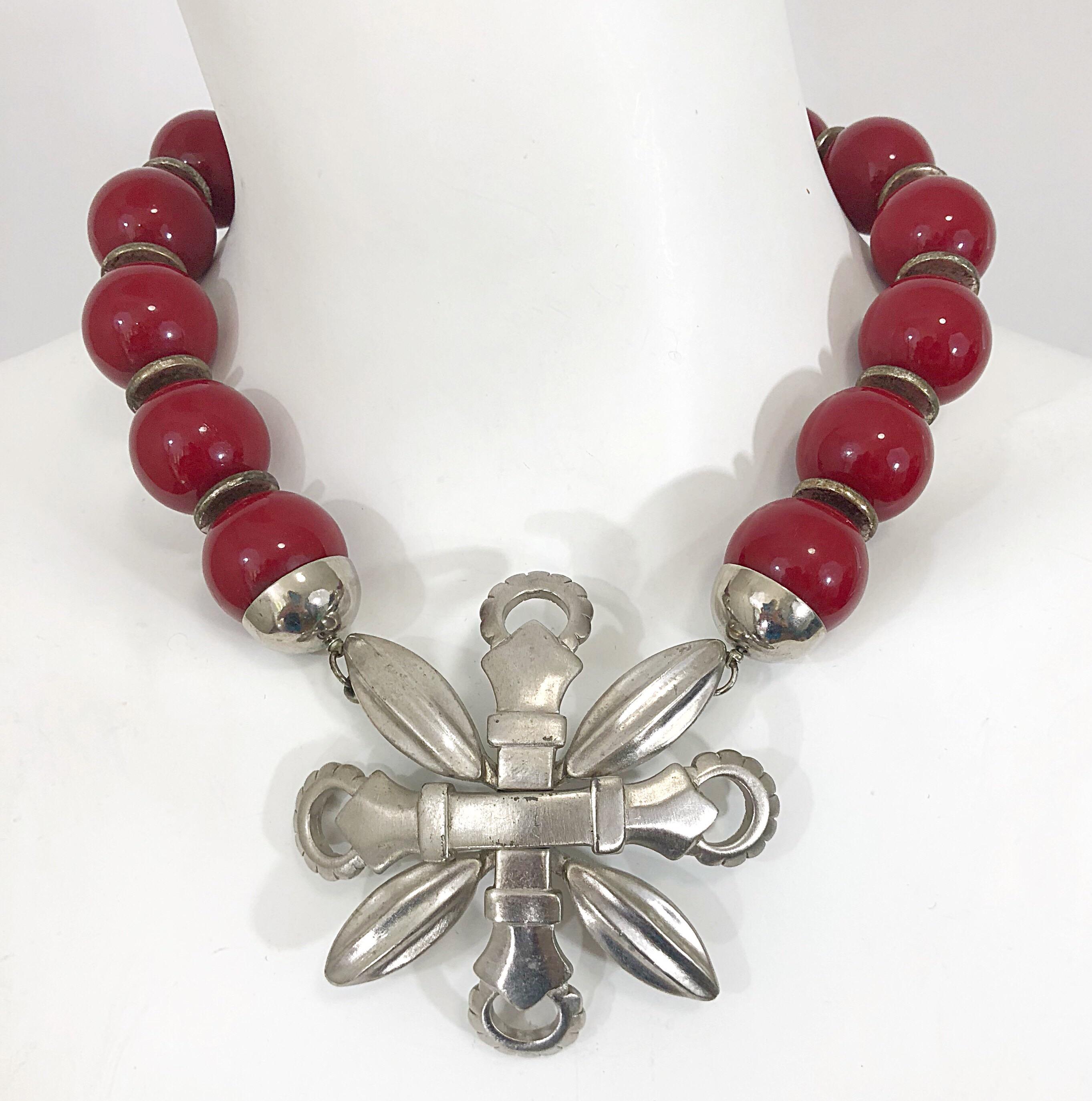 Rare vintage 1960s PIERRE CARDIN red and silver chrome brutalist shield necklace!! Features oversized red beads, with a unique oversized shield as the front clasp. A great bold statement piece that can really make any outfit! In great condition.