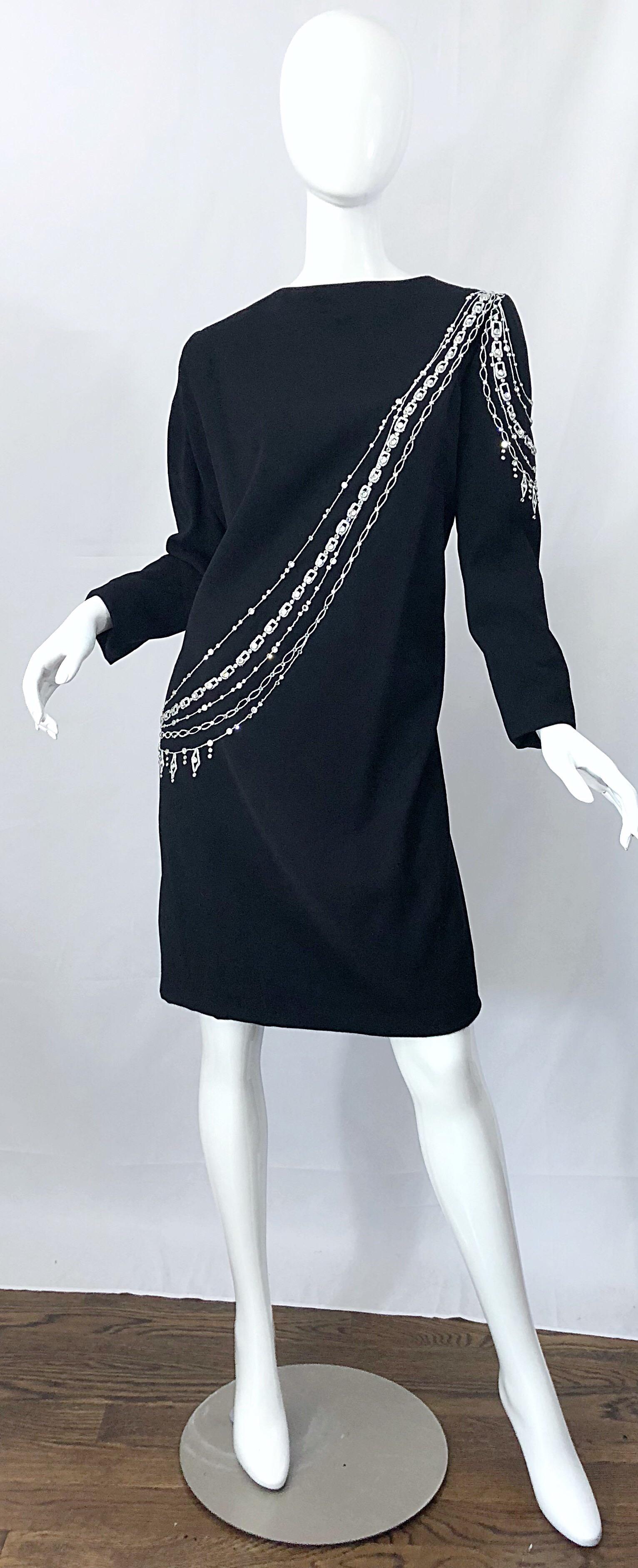 Amazing vintage BOB MACKIE plus size black long sleeve dress! Features hand-sewn rhinestones and beads with silver threading. One pocket at the left side of the hip. Hidden zipper up the back with hook-and-eye closure. Very flattering and forgiving
