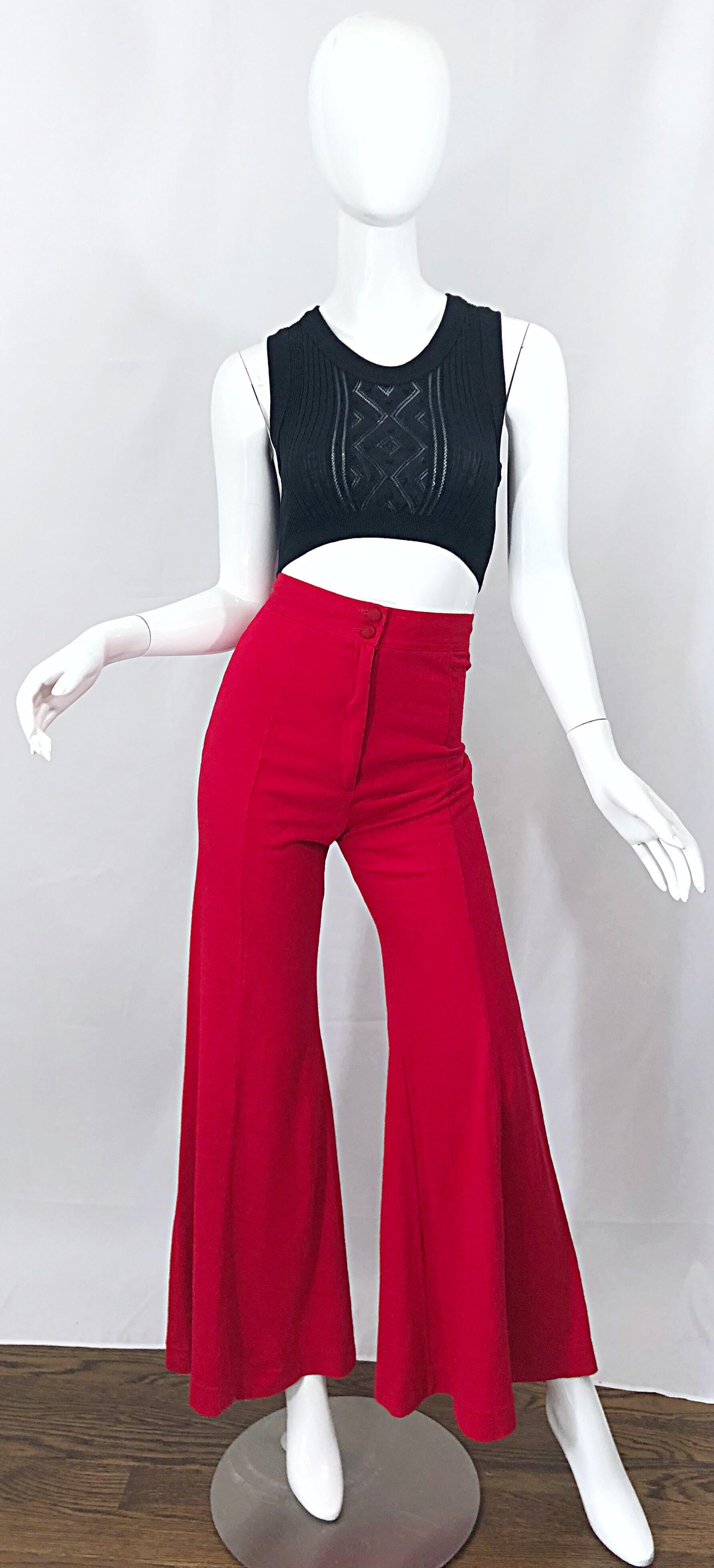 Ultra rare and collectible 70s ALLEY CAT, by BETSEY JOHNSON lipstick red high waisted flared leg bell bottoms! From one of Johnson's first labels, these rare pants are for the musuems! Flattering high waisted fit with two red fabric covered buttons