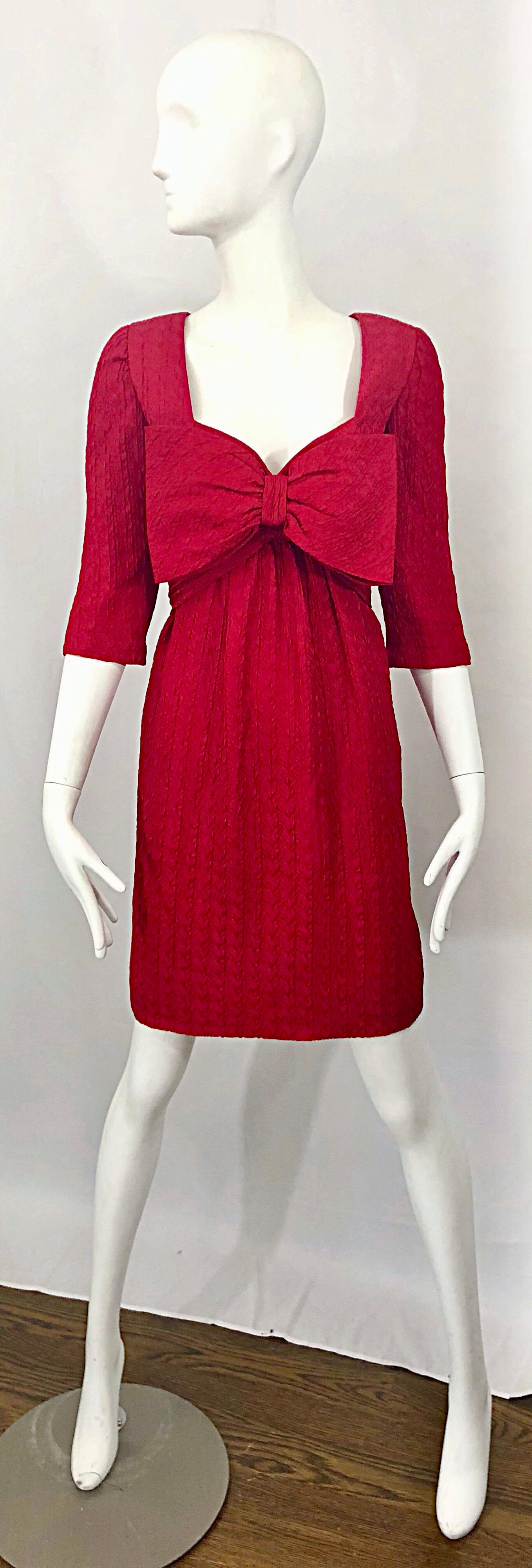 Gorgeous vintage late 1980s / 80s OSCAR DE LA RENTA lipstick red 3/4 sleeve silk bow dress! Features a sweetheart neckline, with an oversized Avant Garde red bow attached at the bust. Hidden zipper up the back with hook-and-eye closure. 3/4 sleeves