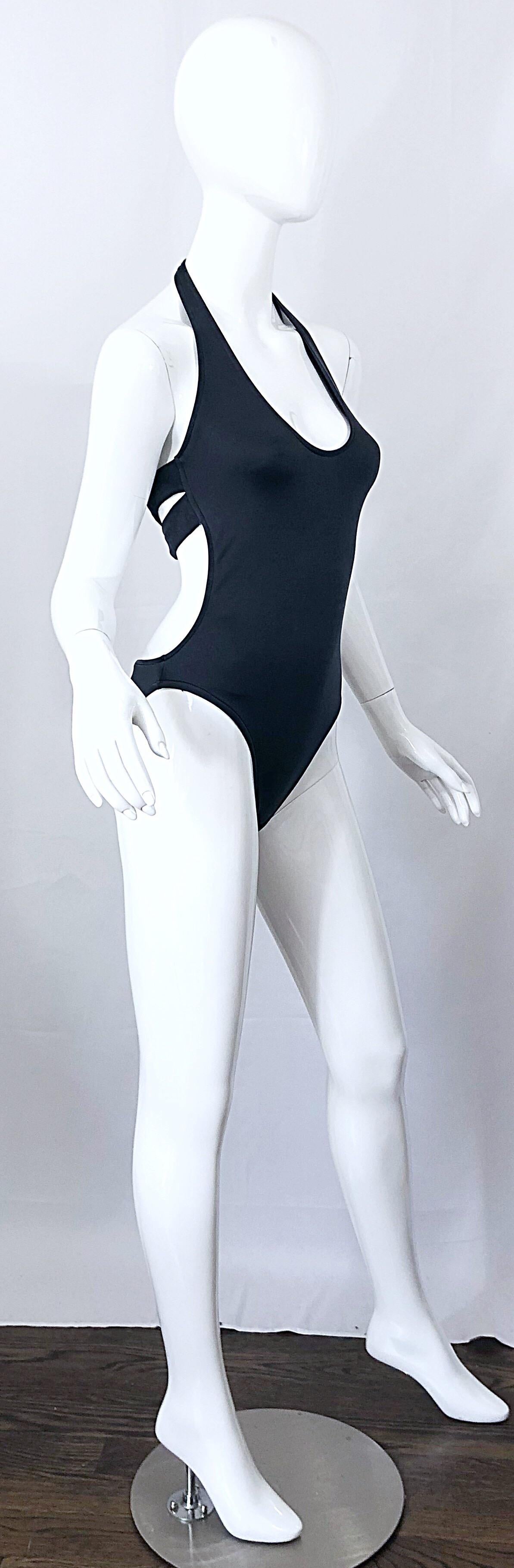 Sexy never worn 90s vintage CALVIN KLEIN slate grey 
one piece cut-out swimsuit or bodysuit! The perfect alternative to black, this beauty features just the right amount of metallic sheen. Criss-cross cut out back. Easy to wear, and super slimming.