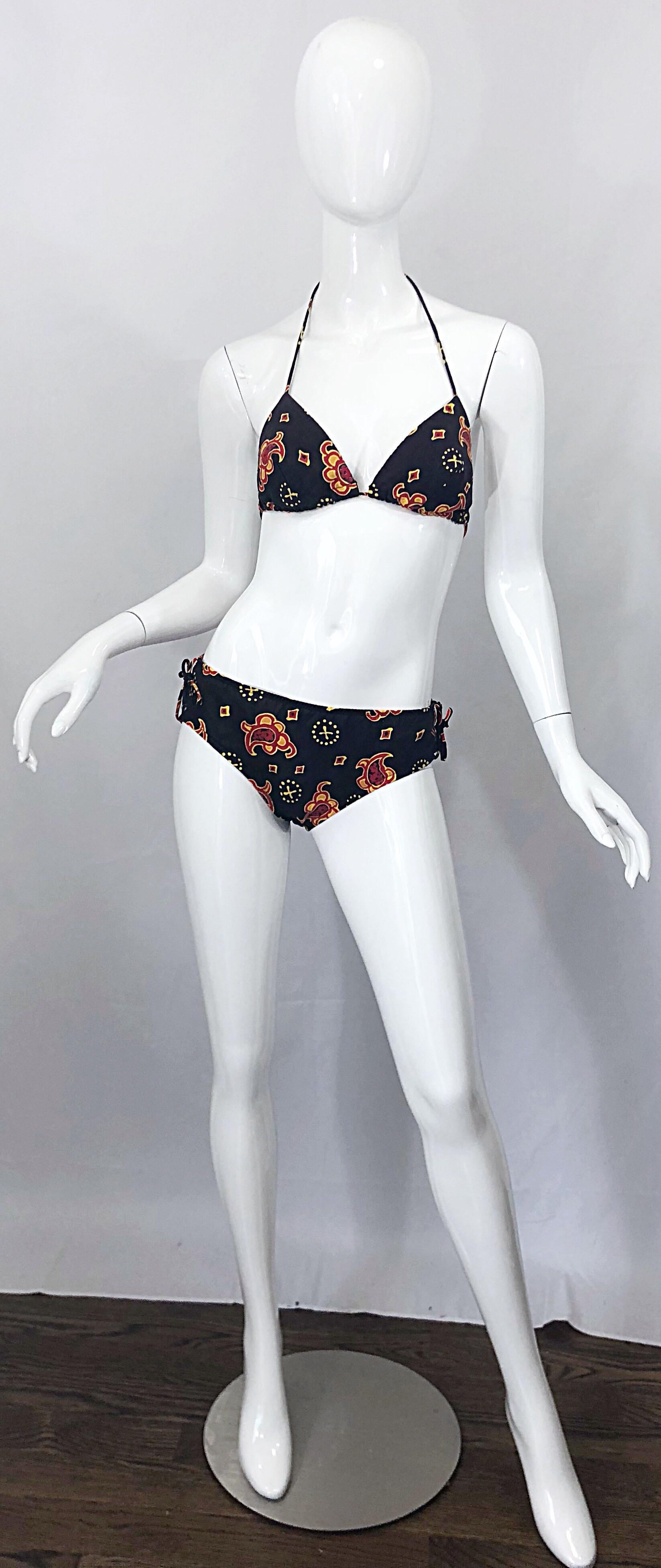 Incredible 1970s JOSEPH MAGNIN brown bandana paisley print two piece cotton bikini swimsuit ! Features a coffee brown color with vibrant pops of red and yellow throughout. Halter neck style ties at top back neck and center back. Low rise bottoms