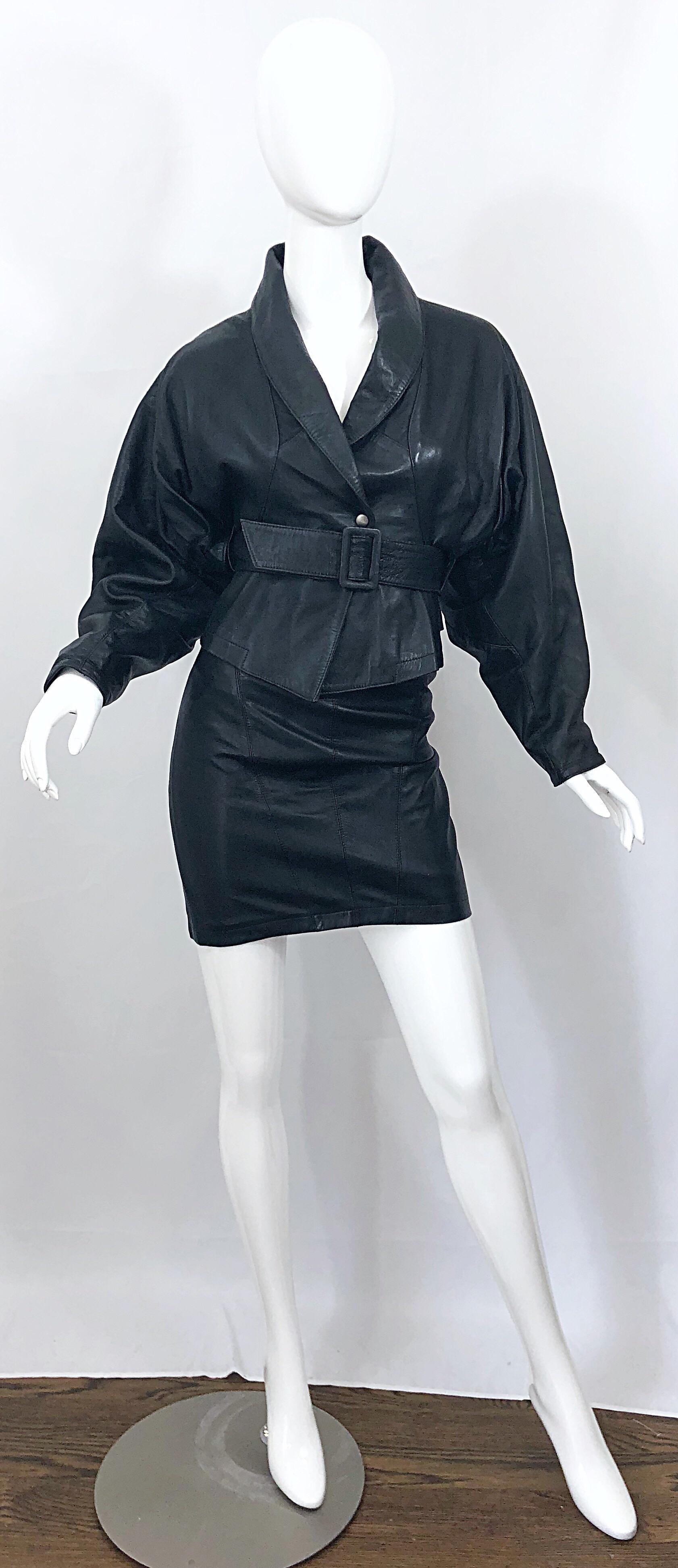 Avant Garde 1980s MARC LAURENT of Paris black leather jacket and mini skirt ensemble! Jacket features dolman sleeves with a clinched wasp waist. Detachable matching leather belt. Shawl collar can be worn down or flipped up. Features a hidden