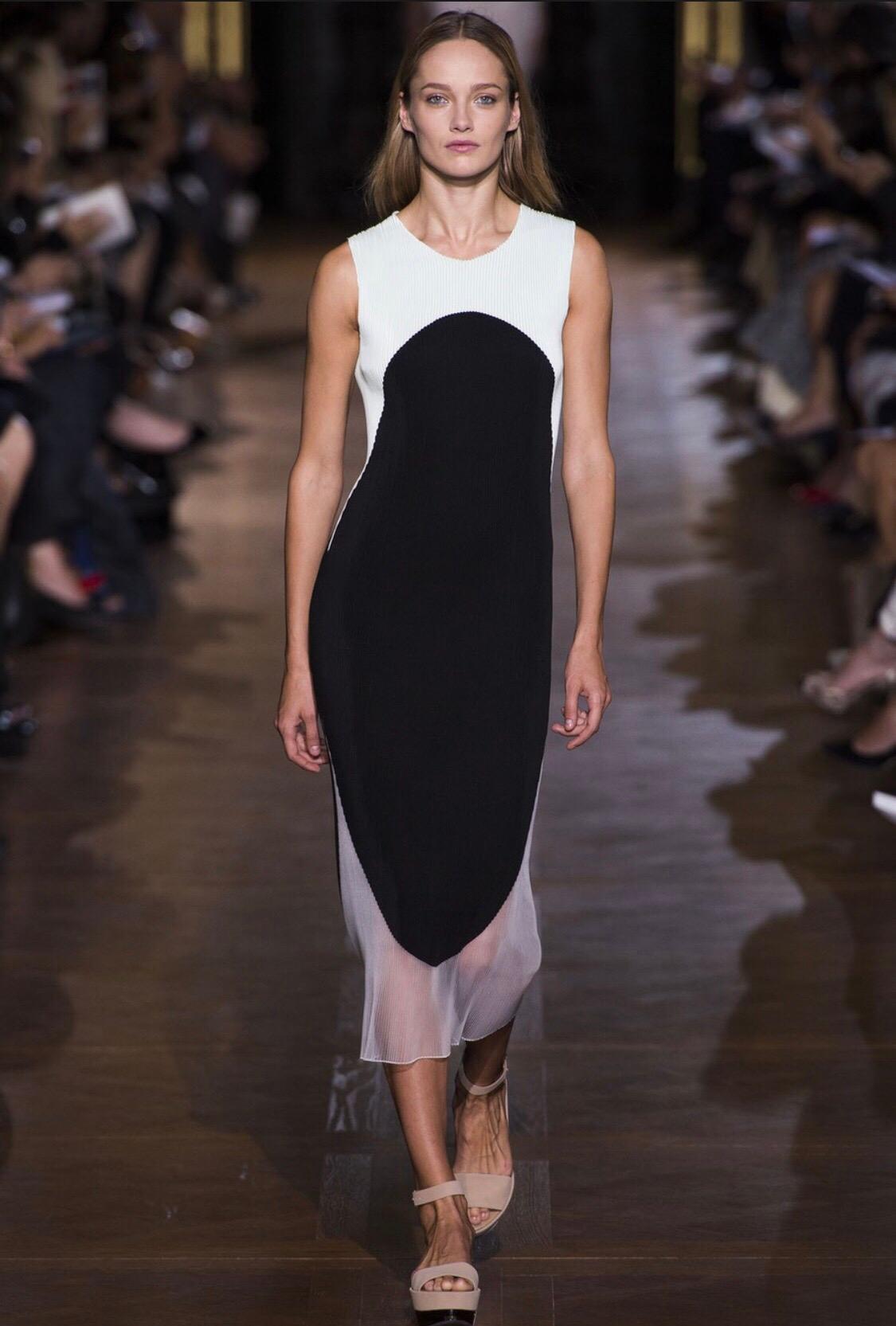 Amazing STELLA MCCARTNEY Spring Summer 2013 pleated color block dress! At first look, I assumed this was an Issey Miyake Pleats Please dress. 
Features mint green on the top, black body and transparent clear sheer panel on the bottom. Simply slips