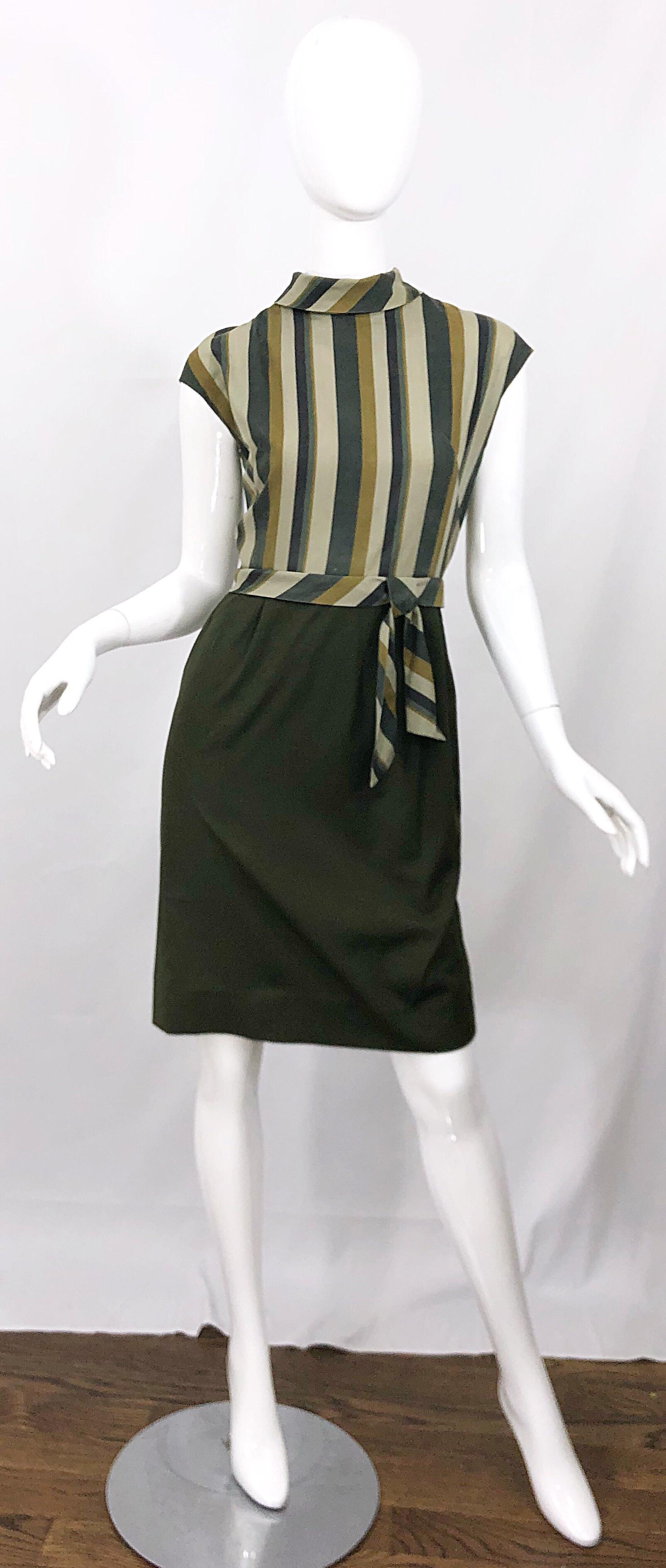 Chic early 60s chartreuse green and olive green cap sleeve cotton dress. Features flattering vertical stripes on the fitted bodice, with a high neck, and attached belt. Dipped back collar. Dark hunter green skirt has some give. Full metal zipper up