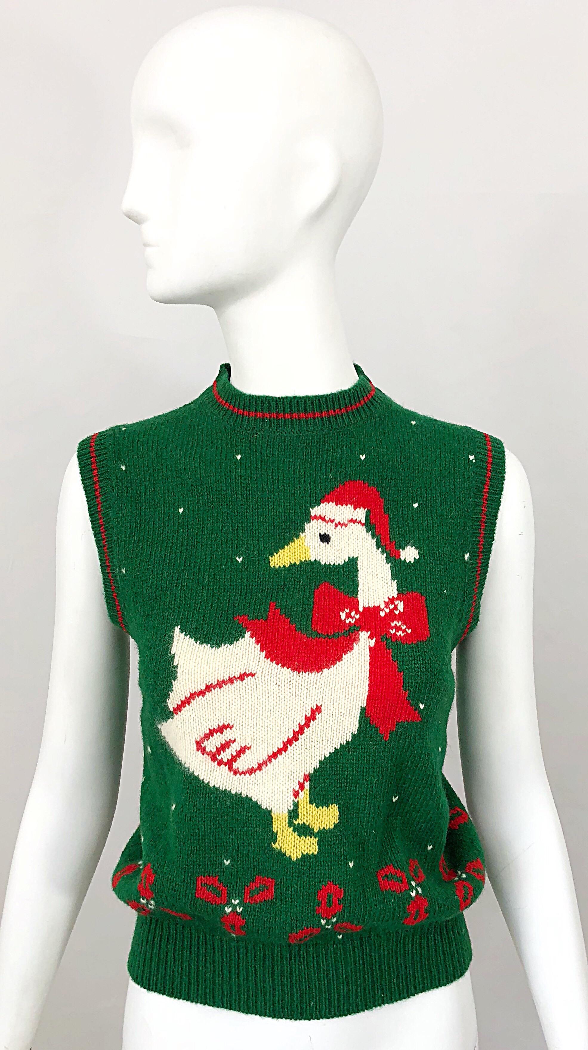 Who said Christmas / Holiday sweaters have to be ugly?! This 1970s sweater vest is so cute! Soft wool, with intarsia weaving. Features a swan on the front with a Santa hat and scarf, with red and green holly and snowflakes. In great