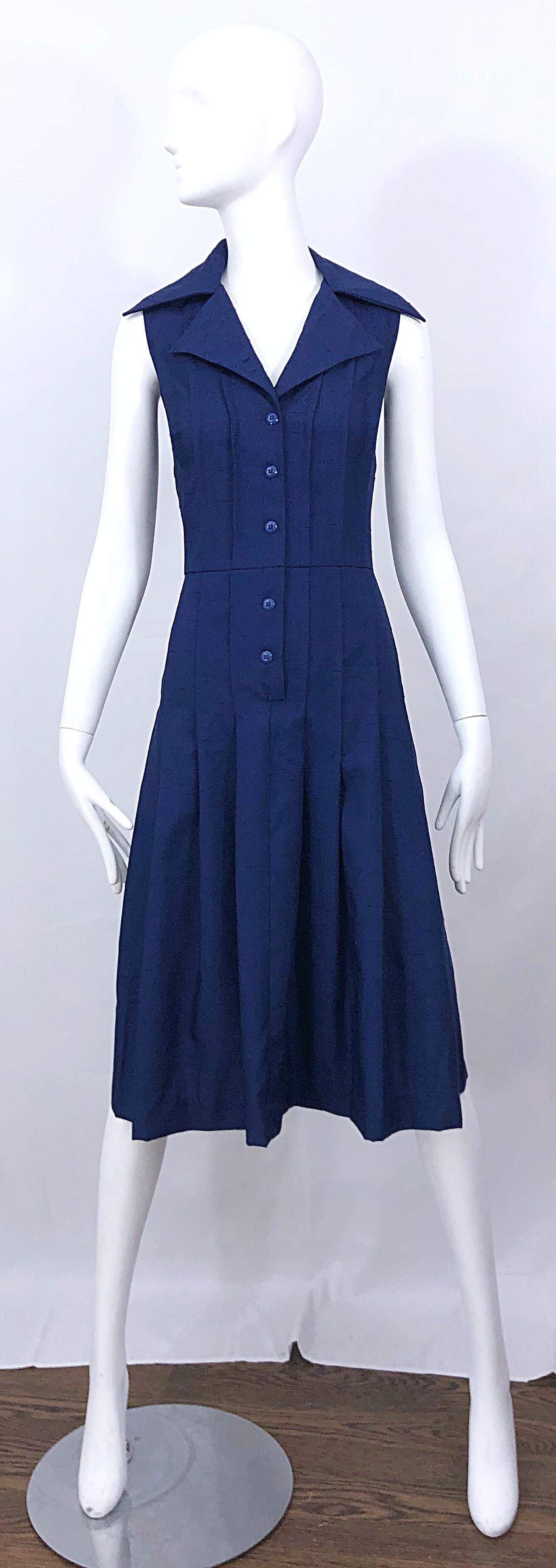 Chic beuatiful early 90s SAKS 5TH AVE. navy blue size 10 sleeveless silk fit n' flare shirt dress! Buttons up the bodice. 1950s style with a fitted bodice and a forgiving full skirt. Avant Garde oversized pointed collar. The perfect dress that can