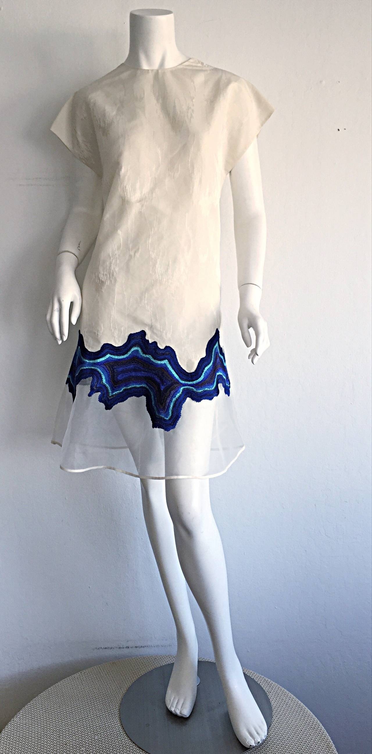 Gorgeous early 2000s ivory Philip Lim dress! Beautiful ivory moire dress, with intricate blue embroidered detail at hem. Hidden zipper up back. Never worn, in great condition. Will fit most sizes, due to A-Line fit. 
Marked Size US