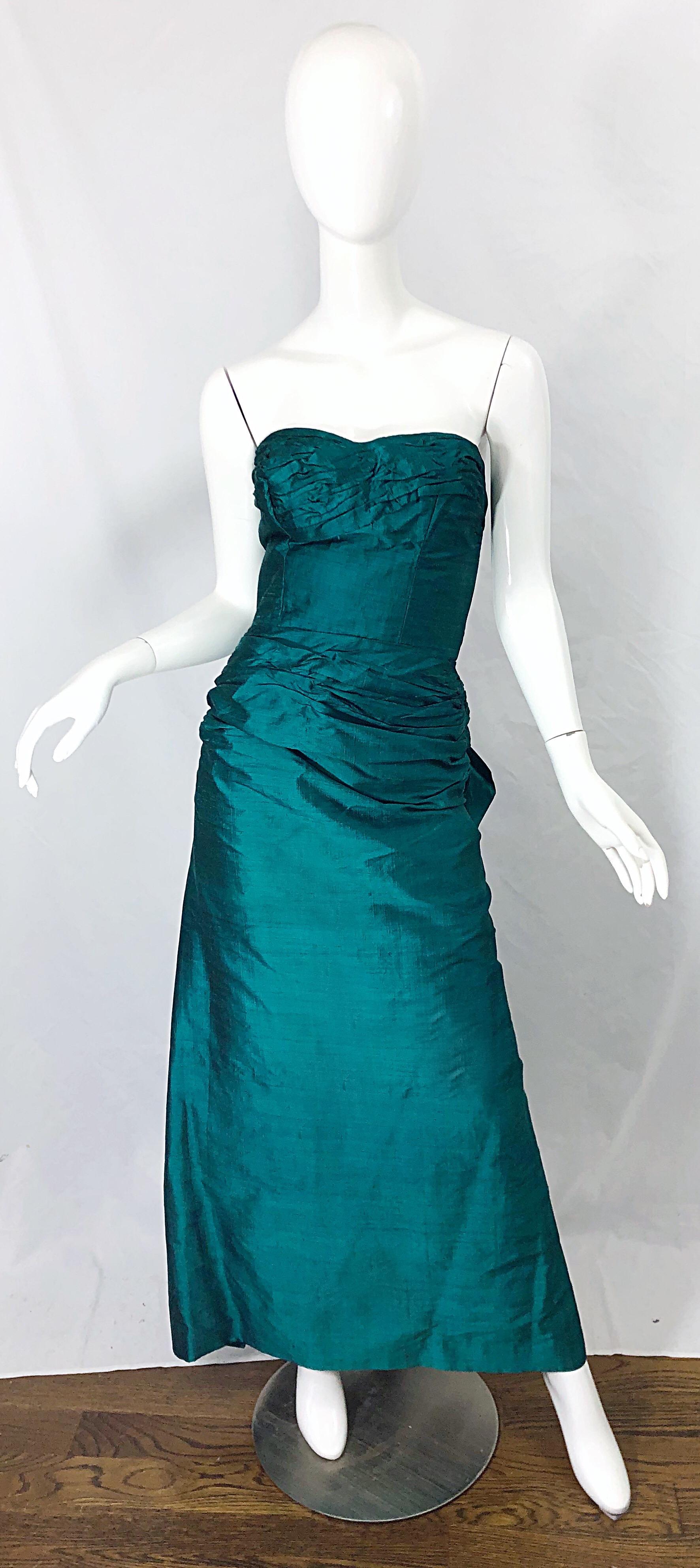 Bombshell 1950s emerald green silk shantung full length dress! Fabulous flattering wiggle fit, with couture qualities. Flattering ruching detail at the waist. Avant Garde oversized half bow detail on the back. Full metal zipper up the side with