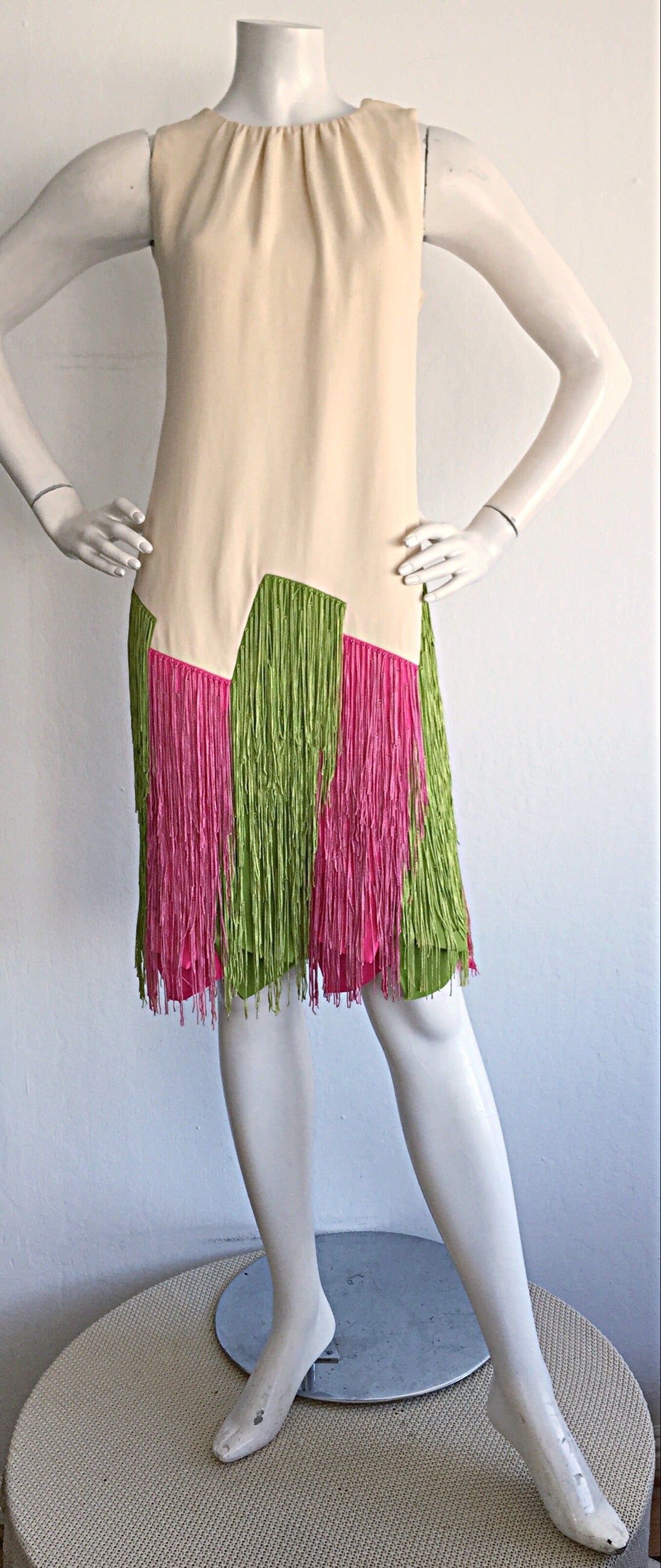 Extremely rare Jean Louis dress for I. Magnin. Ivory color, with haute couture draping. Original fringe/Carwash hem in vibrant hues. Approximately Size Small-Medium 

Measurements:
Up to 38 inch bust
Up to 34 inch waist
Up to 40 inch hips
39