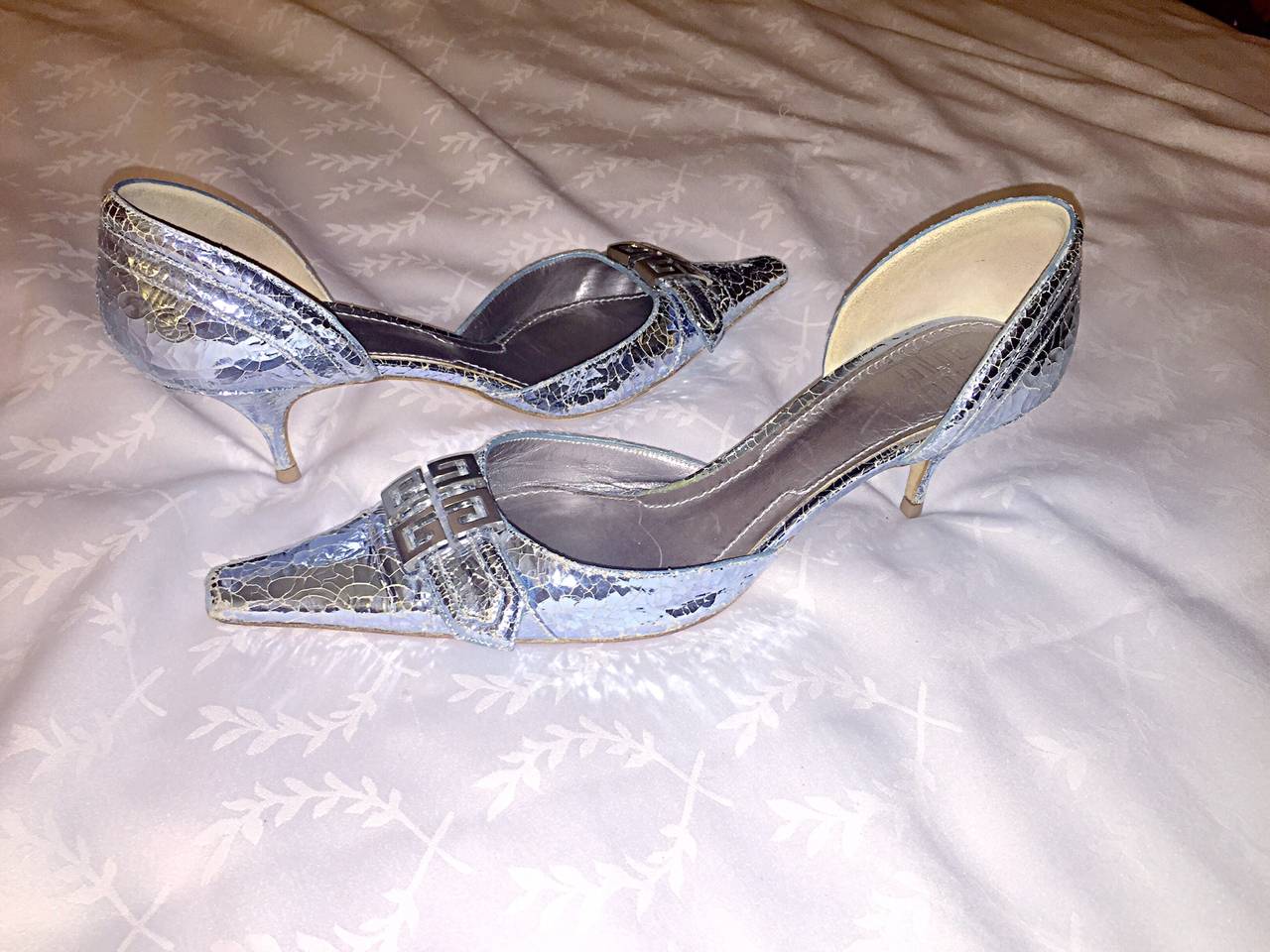 Beautiful brand new pair of early 2000s silver Givenchy heels! Just the right amount of height. Silver Givenchy logo plate on each toe. Unique shaped toe that is very flattering. Leather soles. Never been worn. Made in Italy. Marked Size 40 / US 10