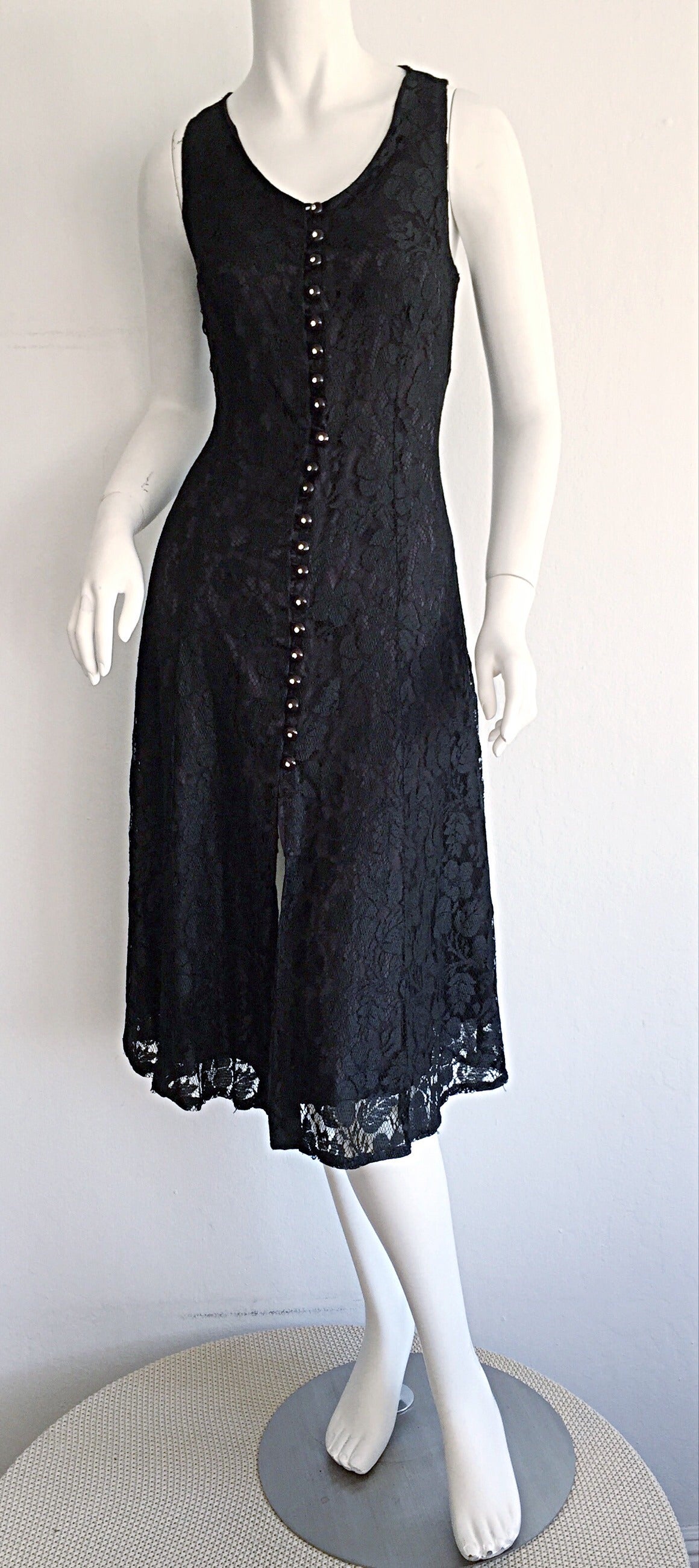 Beautiful 1990s black Paco Rabbane lace dress! Features functional black buttons, with rhinestones up the front. Tie at back to control desired fit. Fully lined. In great condition. A flirty number that will be your new go-to little black dress!