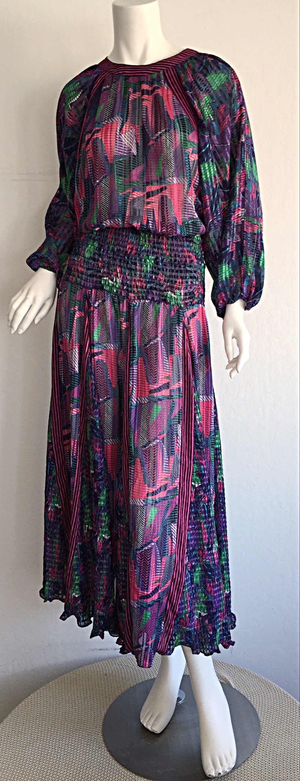 Wonderful vintage 1980s bohemian colorful dress! Beautiful abstract prints, mixed with stripes. Pleated  skirt features a variety of panels, that look incredible when worn. Chic flowy ballon sleeves. Button closure at back neck. Perfect from day to
