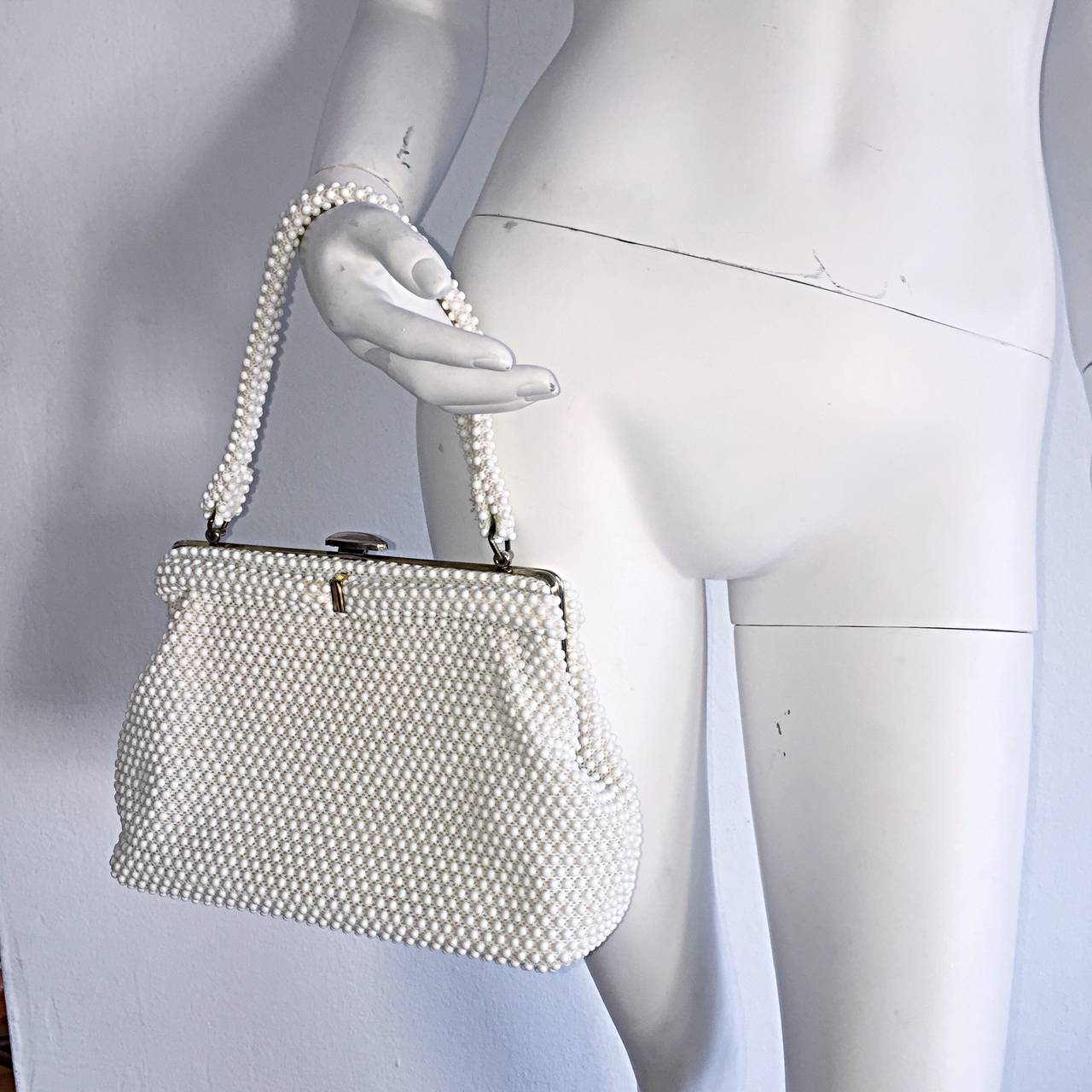 Beautiful white 1960s 'Goosebump' beaded evening bag! Classic style, with a modern size that will easily accommodate plenty. Clasp closure, with a strap that can be worn on the hand, or over the shoulder. Features interior pocket. In great