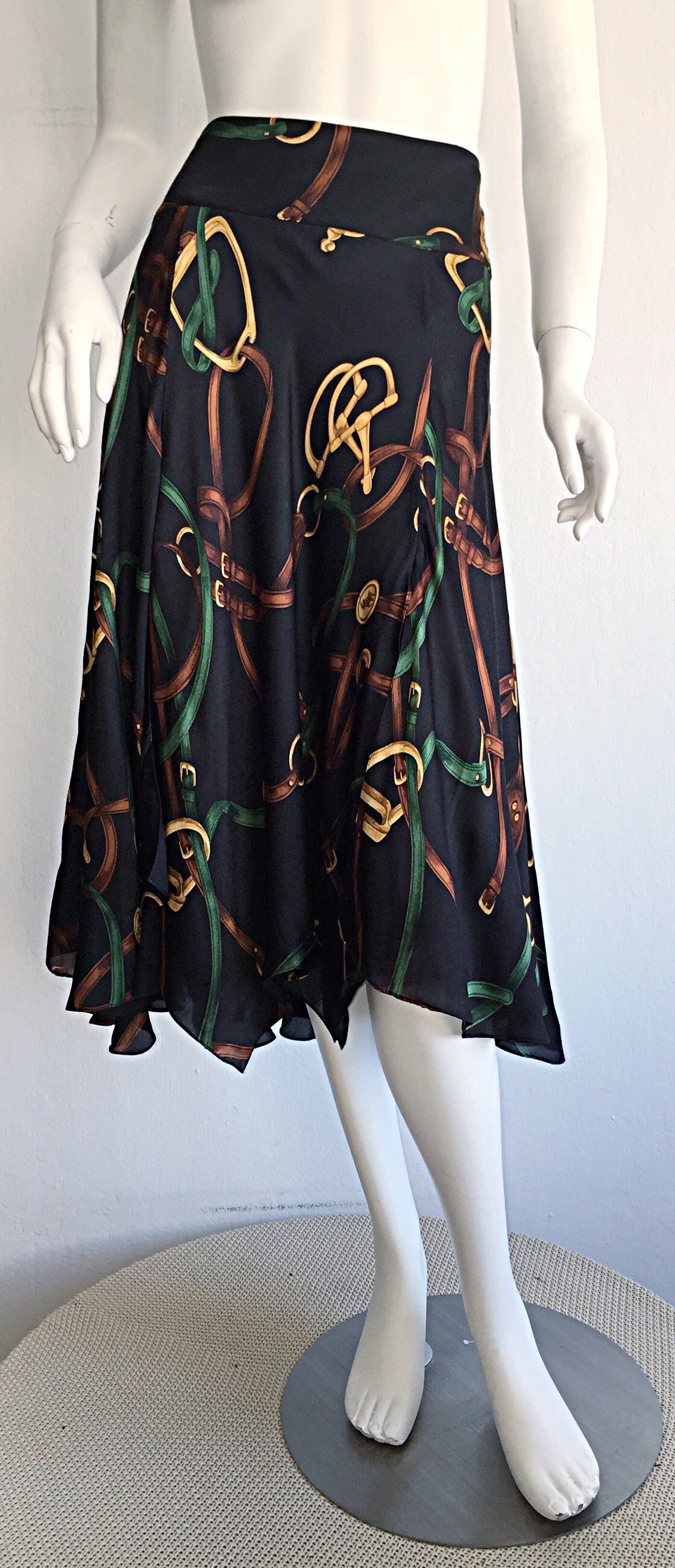 Iconic vintage Ralph Lauren 'Blue Label' silk skirt! Handsome equestrian theme, with horsebits and belts. Panels of flowy silk make for a flirty fit. Black background, with green, yellow, gold and brown accents. Fully lined. In great condition. Size