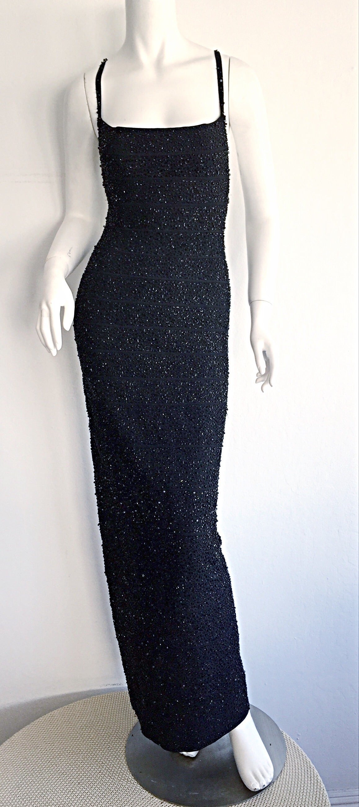 Featuring an astonishing early 1990s Herve Leger runway sample bandage dress!!! Has the runway model's name attached to tag. Jet black color, in signature bandage style, with all-over beading. Criss-Cross back, with slit up the back bottom. Bodycon