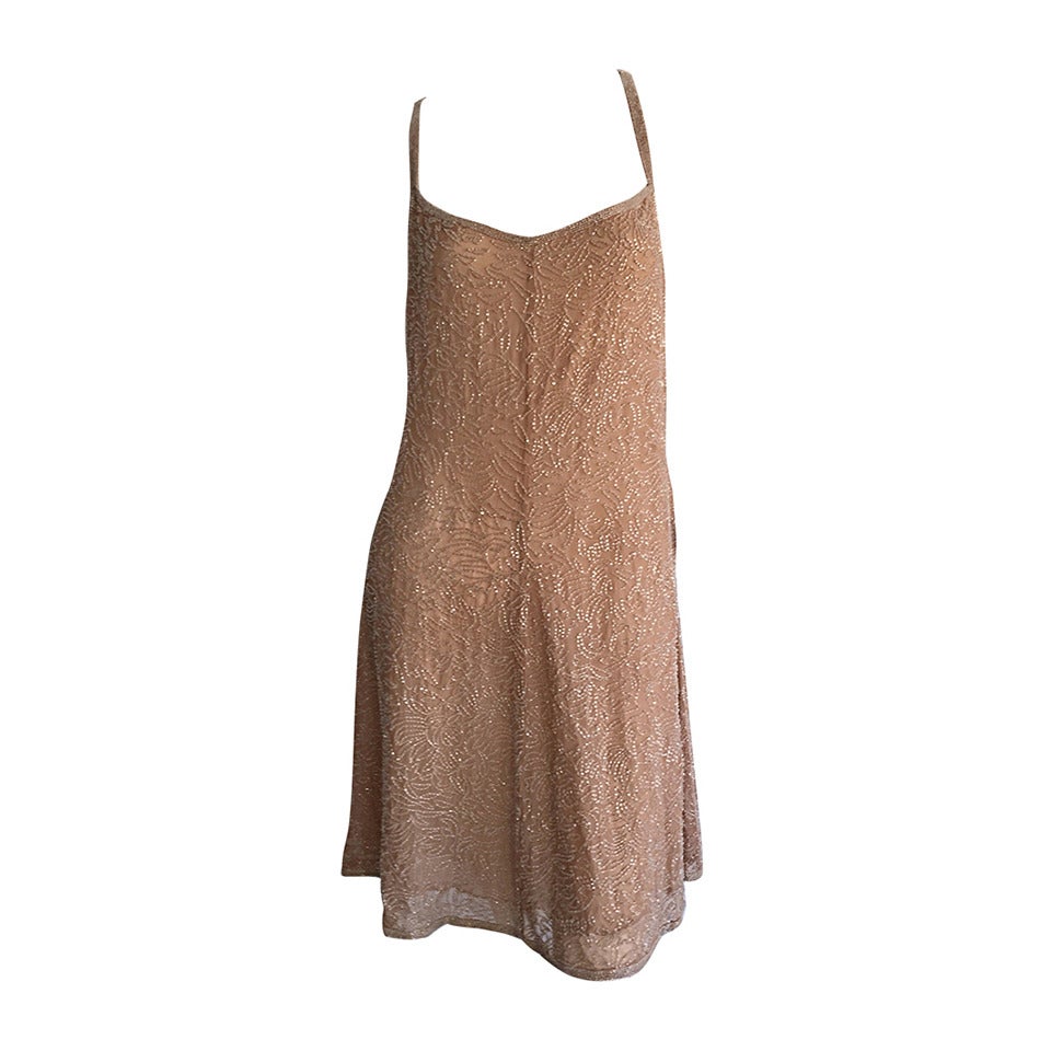 Stunning brand new with tags vintage 1990s Calvin Klein champagne silk dress, encrusted with all-over glass beads.  Intricate hand beaded work, with an incredible design. Retailed for $2,800. Beautiful fit, with flattering criss-cross beaded back. A