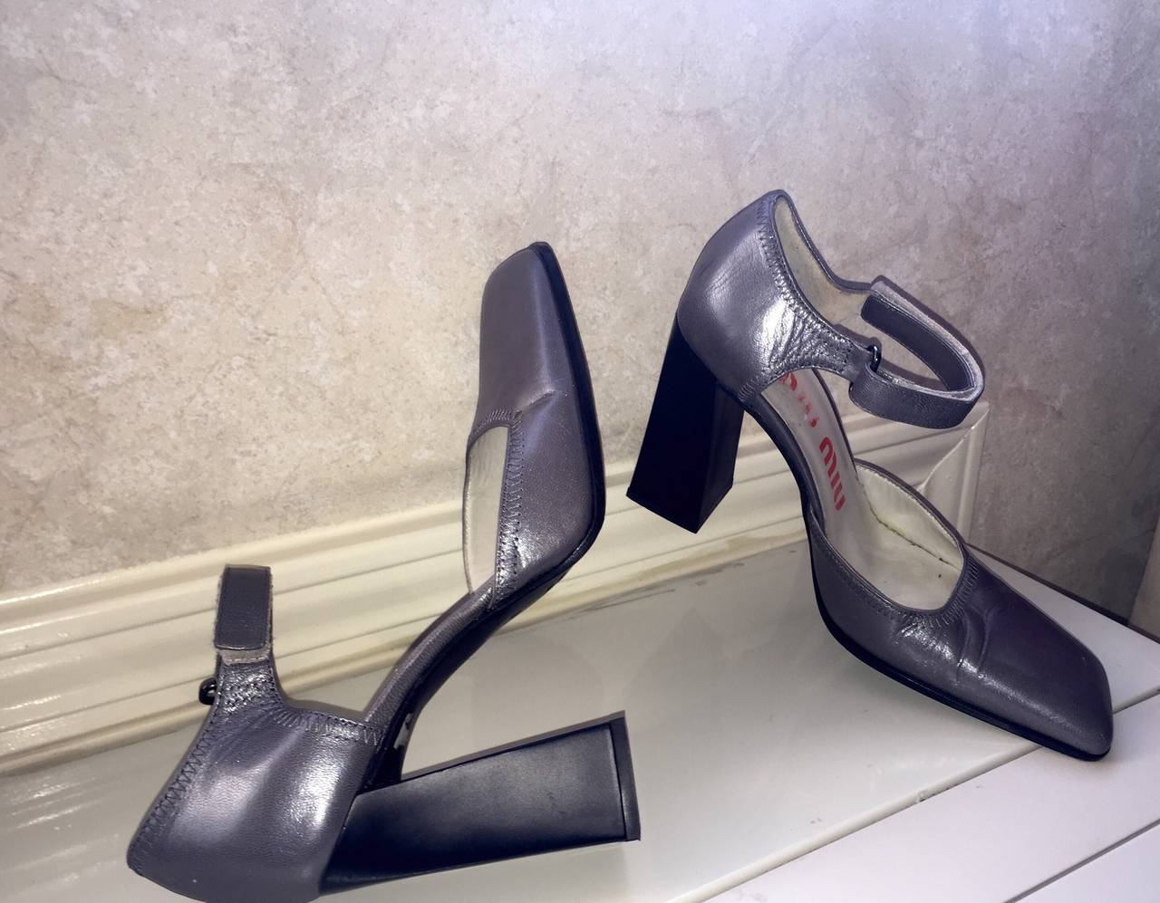 Incredibly rare 1990s Miu Miu heels! Architectural style, with a blocked heel, and asymmetrical toe. Perfect gunmetal leather that goes with everything! Can easily be dressed up or down. In great condition, with very minor wear to leather. Made in