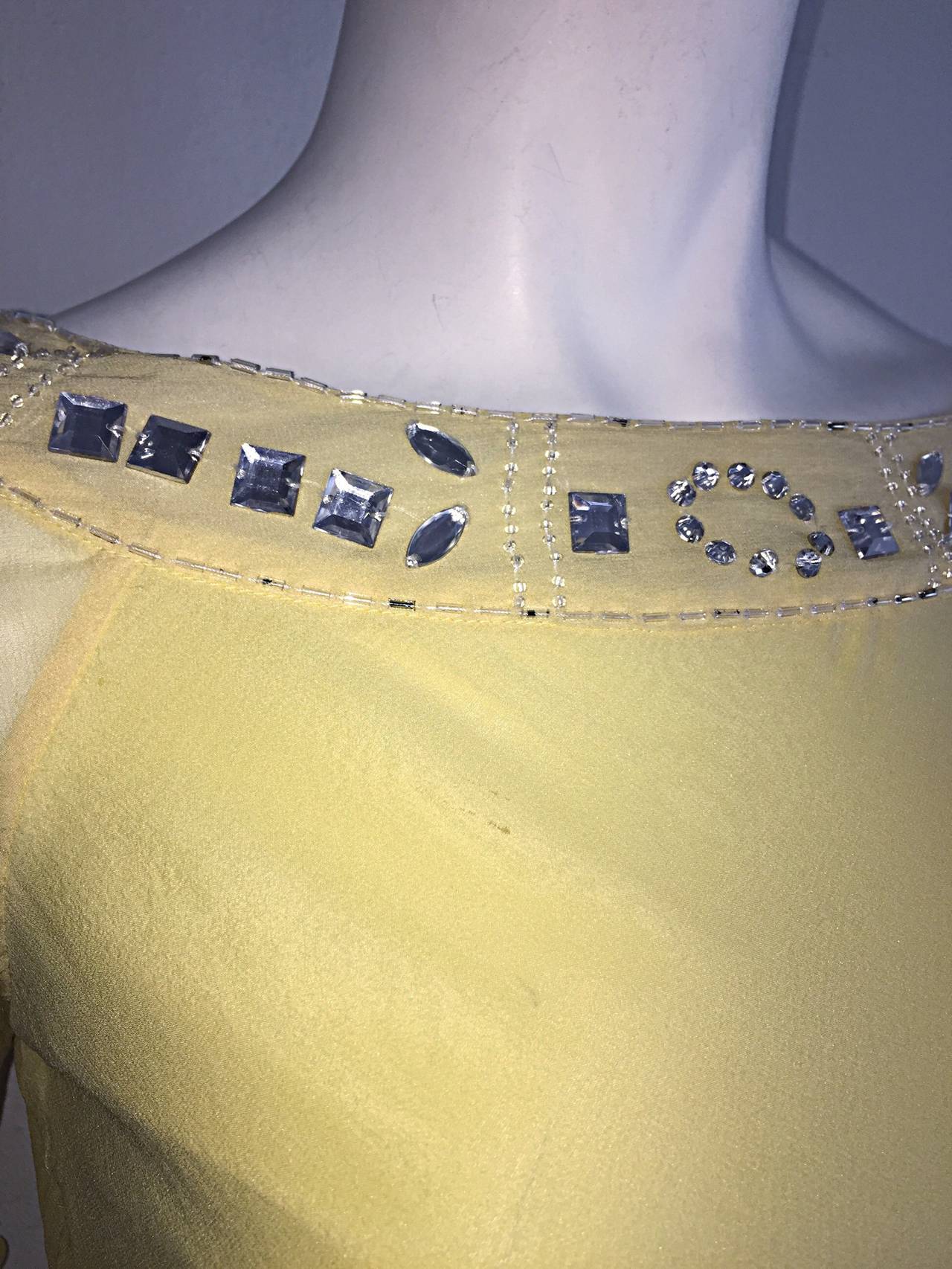 Gorgeous vintage Chloe blouse, designed by Karl Lagerfeld! Butter yellow color, on scrumptious silk chiffon. Angel-like bell sleeves, with rhinestones encrusted around collar, and at cuffs. Detachable matching silk tie belt. Can easily transition