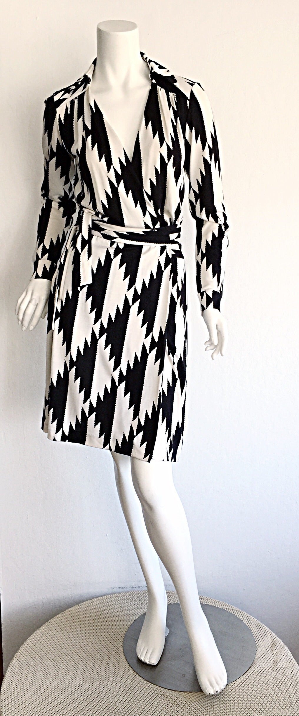 Incredible 1990s silk wrap dress by Diane Von Furstenberg! Beautiful, slimming black and white geometric/Aztec print. Signature DVF style, that she is renowned for. Perfect for the office, or great for evening. In great condition. Marked Size 0, but