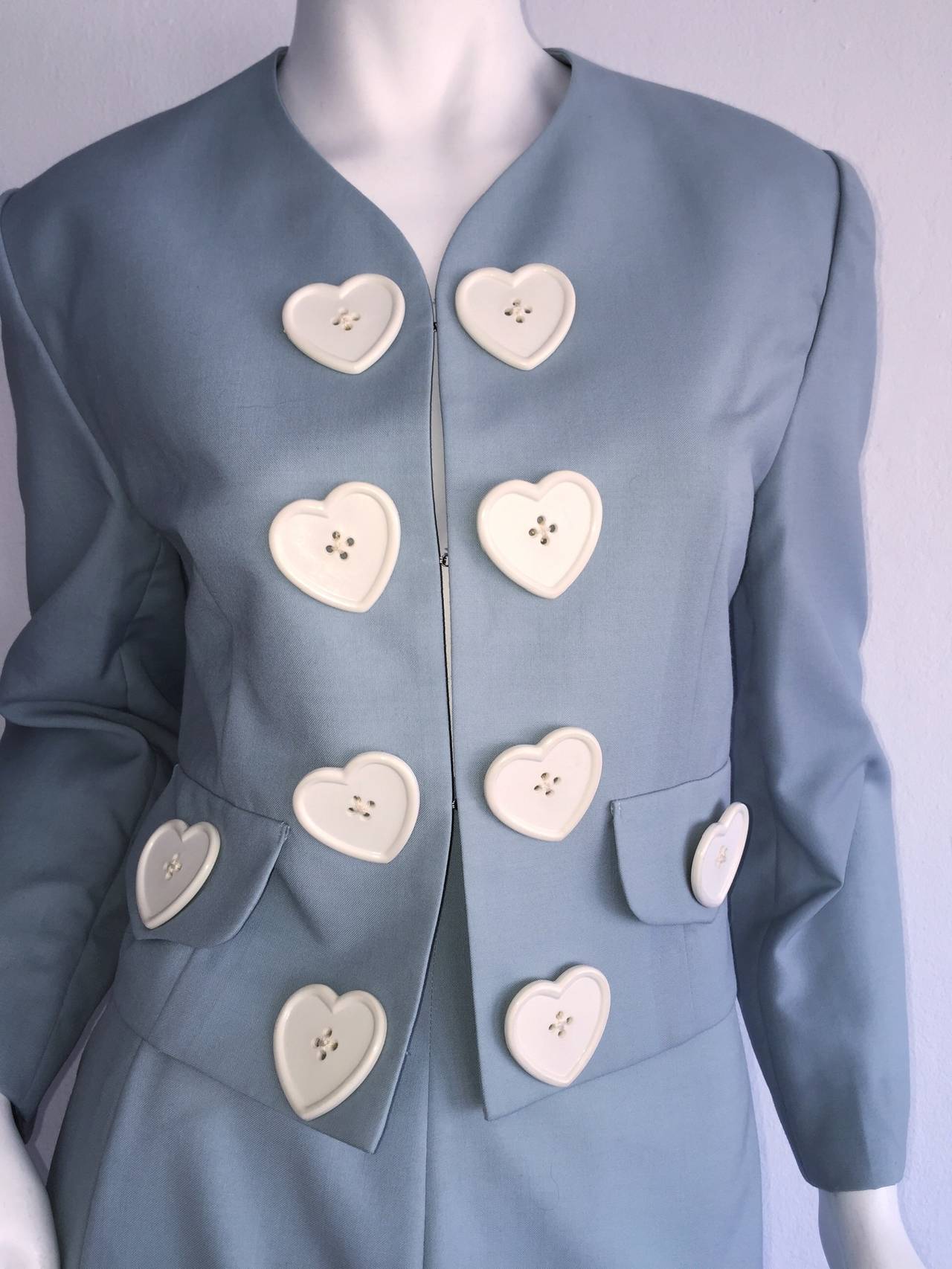 Absolutely Amazing vintage Moschino Cheap & Chic light blue skirt suit! Features white hearts up the front of the jacket, with hook-and-eye closures up the bodice. High waisted pencil skirt. Super lightweight fabric makes great for Spring or Summer!