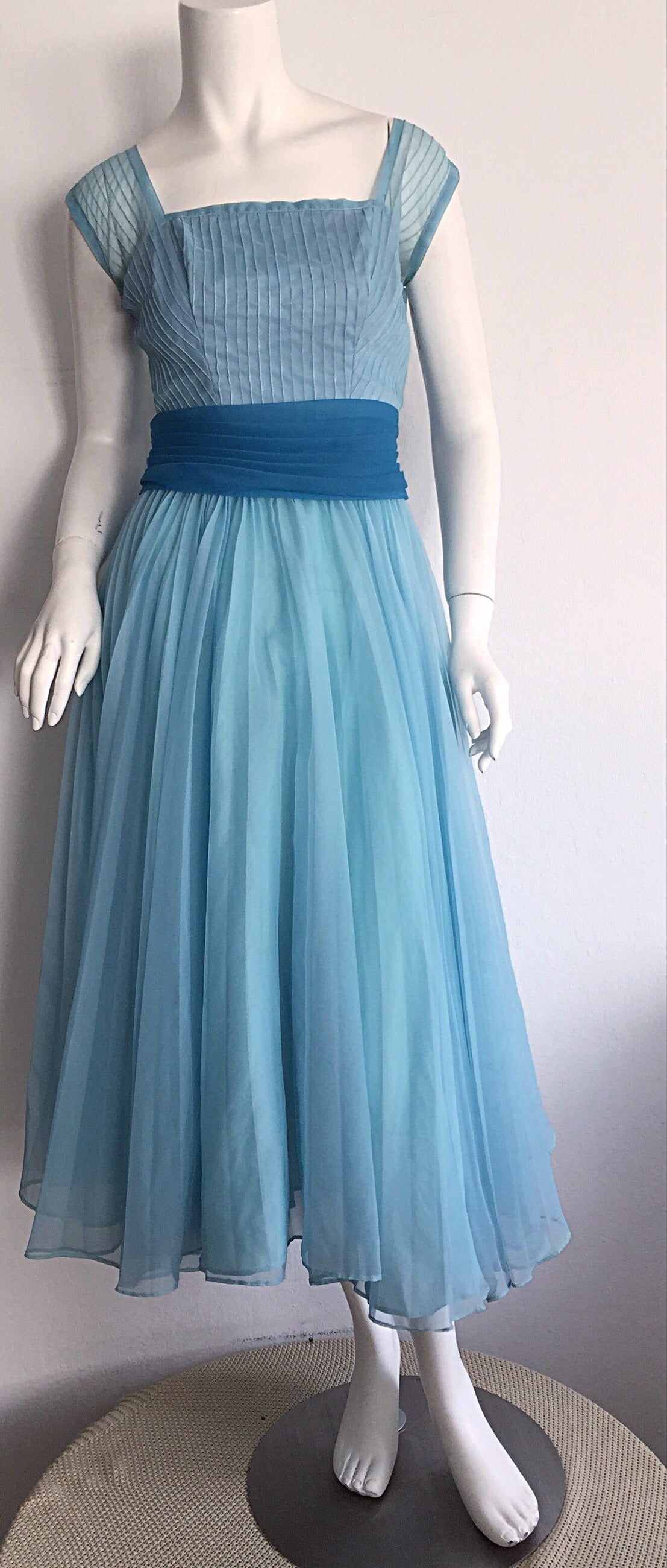 Such a pretty 1950s Fred Perlberg dress! Beautiful from the front, and the back! Intricate detail on the bodice, with an attached blue belt that snaps in the back. Can easily fit a crinoline under the skirt. Wonderful full skirt that looks great on
