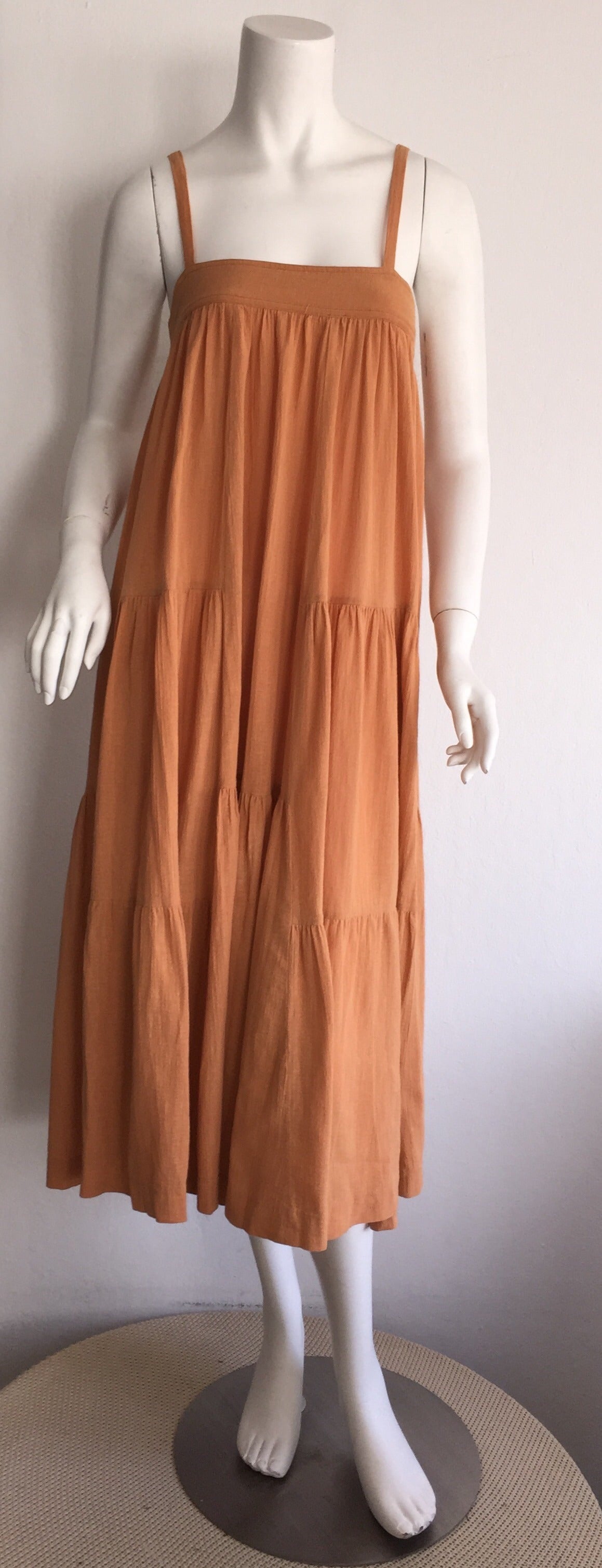 Chic vintage Cacharel cotton patchwork french sundress. Beautiful Terra Cotta color. Patchwork detail throughout the front and back. Straps can easily be tucked in for a strapless look, or to be worn as a maxi skirt. Lightweight cotton that is