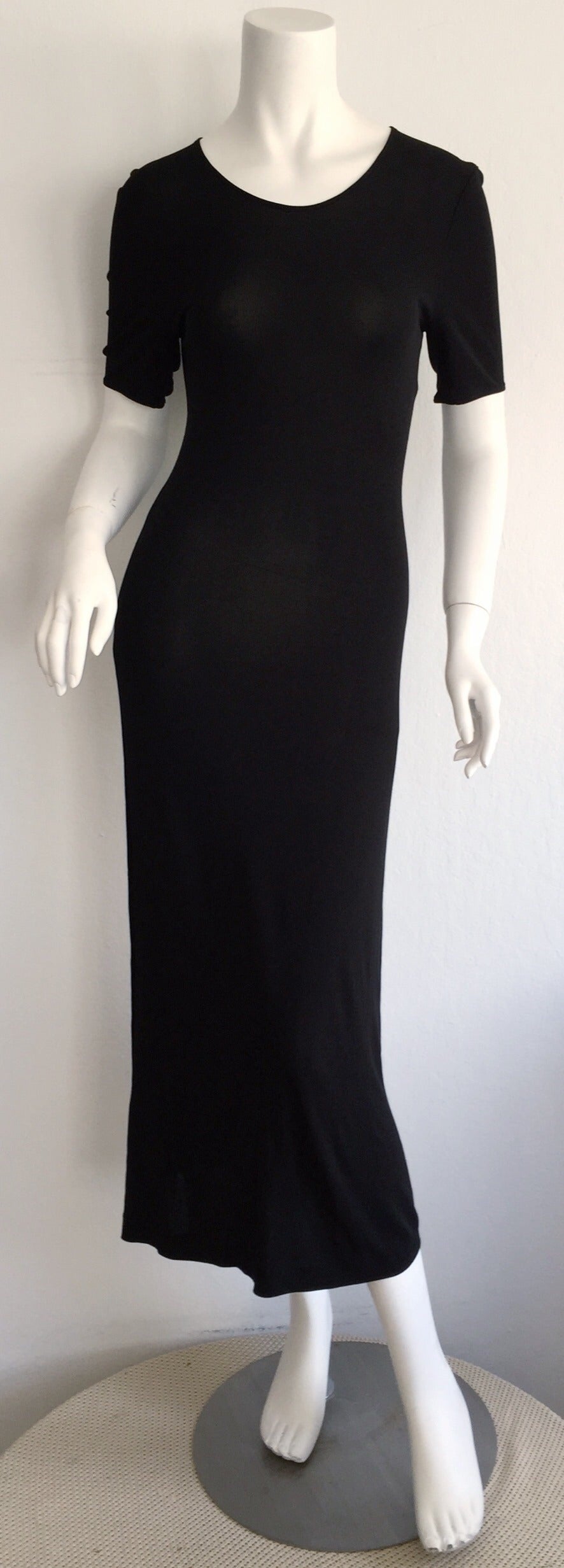 The perfect black dress! Vintage Calvin Klein Collection 90s black rayon jersey dress. Double-ply jersey, with a figure flattering fit. Hugs he body in all the right places. The perfect timeless little black dress! Looks great on it's own, or great