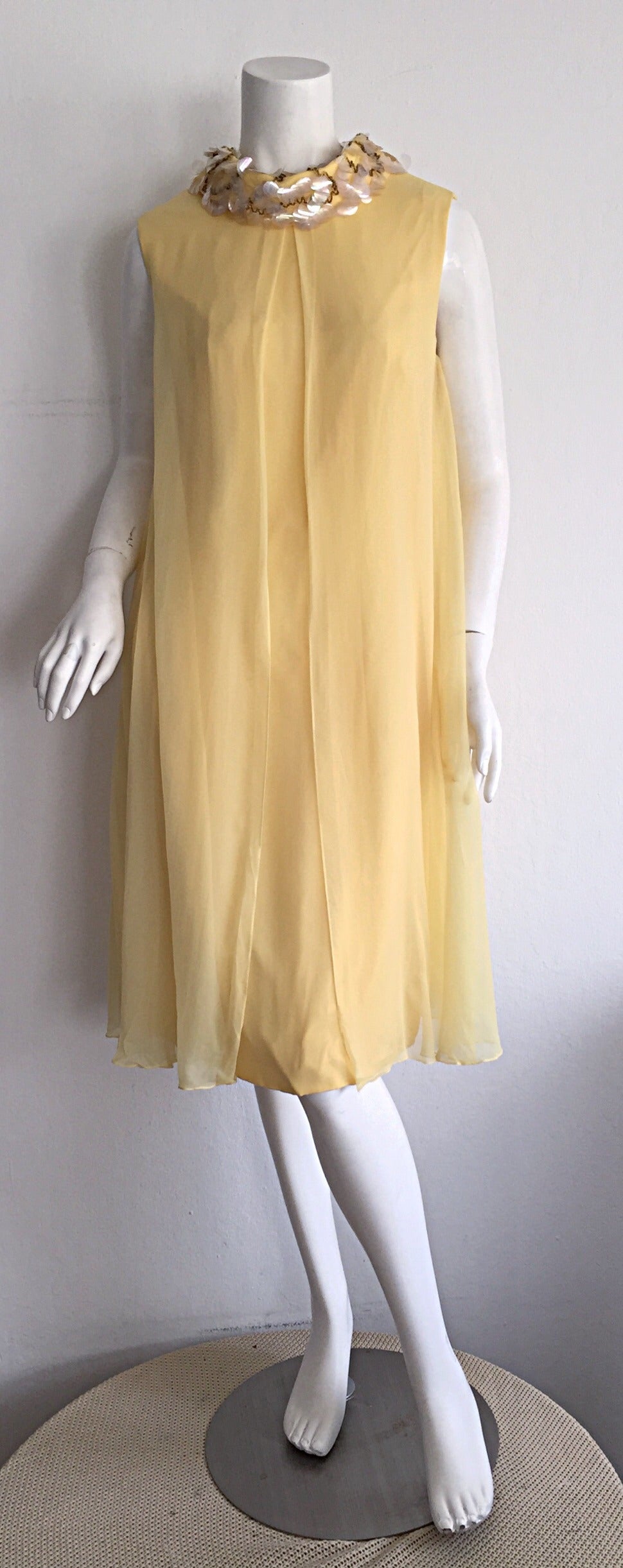 Cutest 1960s vintage Lisa Howard canary yellow chiffon dress! Palliates and beads encrusted around the neck collar. Two panels of chiffon that separate at the front, to form an amazing flowy effect. Metal zipper up the back. Can easily go from day