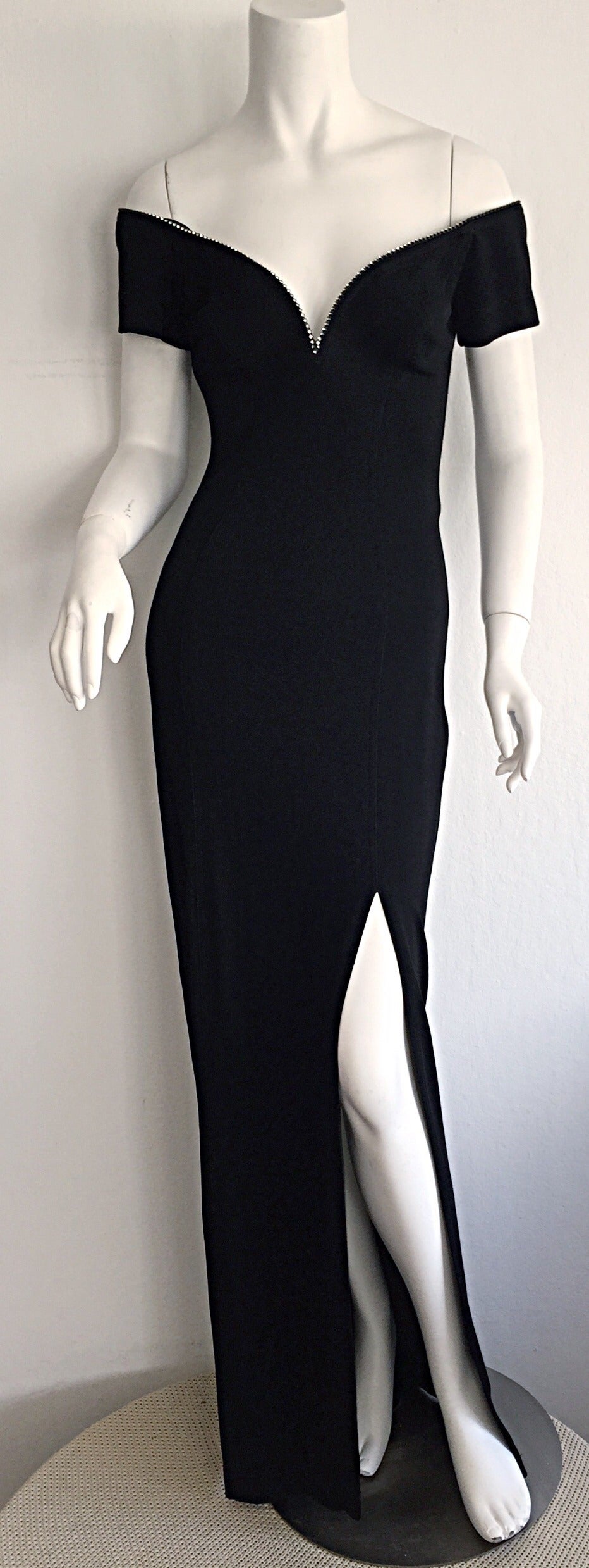 Sexiest vintage Tadashi Shoji black gown! Stretch jersey material. Perfect slit up the side. Rhinestones around bust, and at back neck. A true stunner! In great condition. Approximately Size Small-Medium

Measurements:
34-40 inch bust
26-32 inch