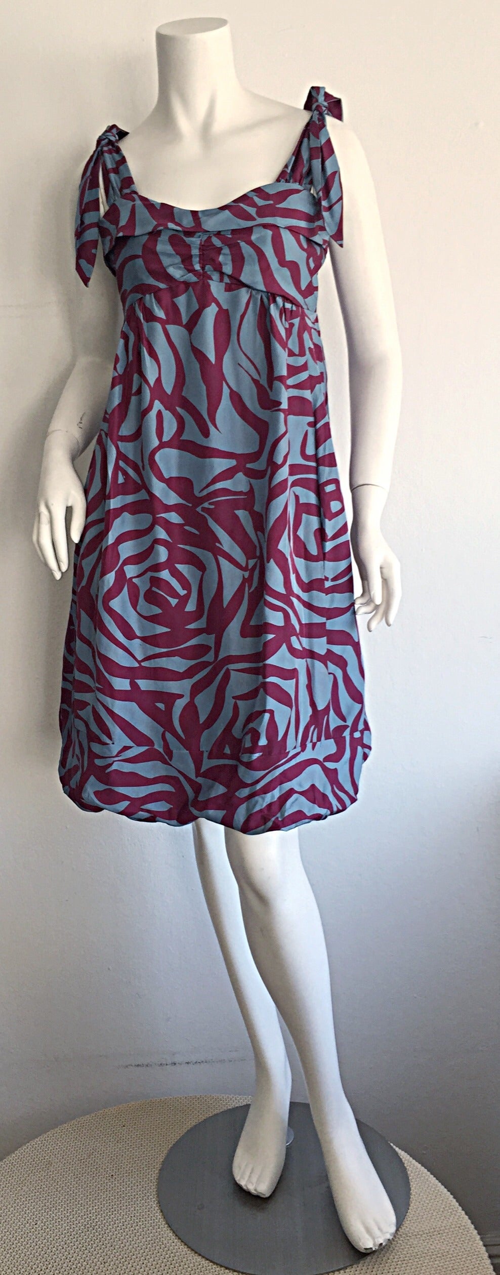 Wonderful Marc Jacobs blue silk bubble dress! Features unique 3-D print of a rose, that looks like zebra at first glance. Chic functional ties at shoulders, with a playful bubble hem. Flattering shelf bust. Great for day or night. Looks good with