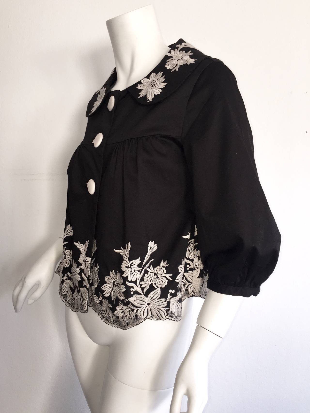 Perfect Marc Jacobs swing jacket! Wonderful black cotton, with white flowers embroidered throughout. Darling pleating detailing at cuffs, and shoulders. Great sleeve volume! Great with jeans, yet perfect over a dress. Full lined. In great condition.