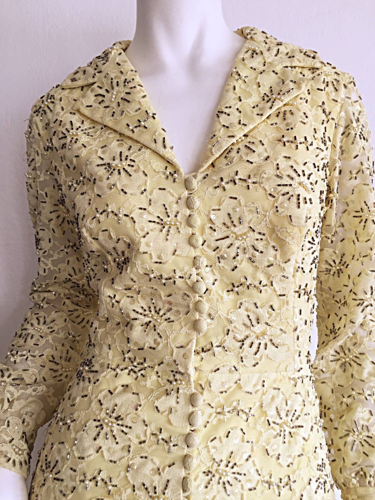 Gorgeous late 1960s / early 1970s pale yellow vintage lace dress. Heavily beaded in ways which compliment and match the lace. Thousands of beads and sequins throughout this wonderful dress! Functional lace covered buttons up the front. Dress is
