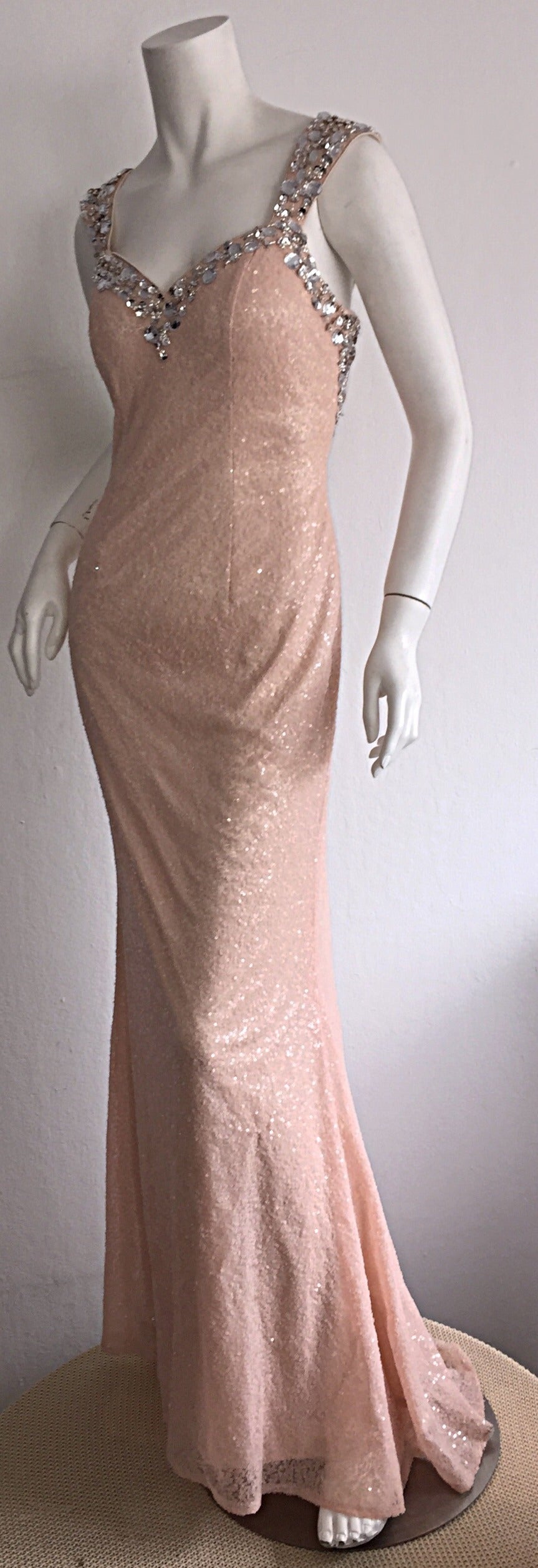 Exquisite early 90s sequin gown! Features thousands of pale pink micro sequins throughout the dress, with crystal embellishments at sleeves, bust, and back. Beautiful mermaid silhouette! A true show-stopper! Excellent craftsmanship--looks to be