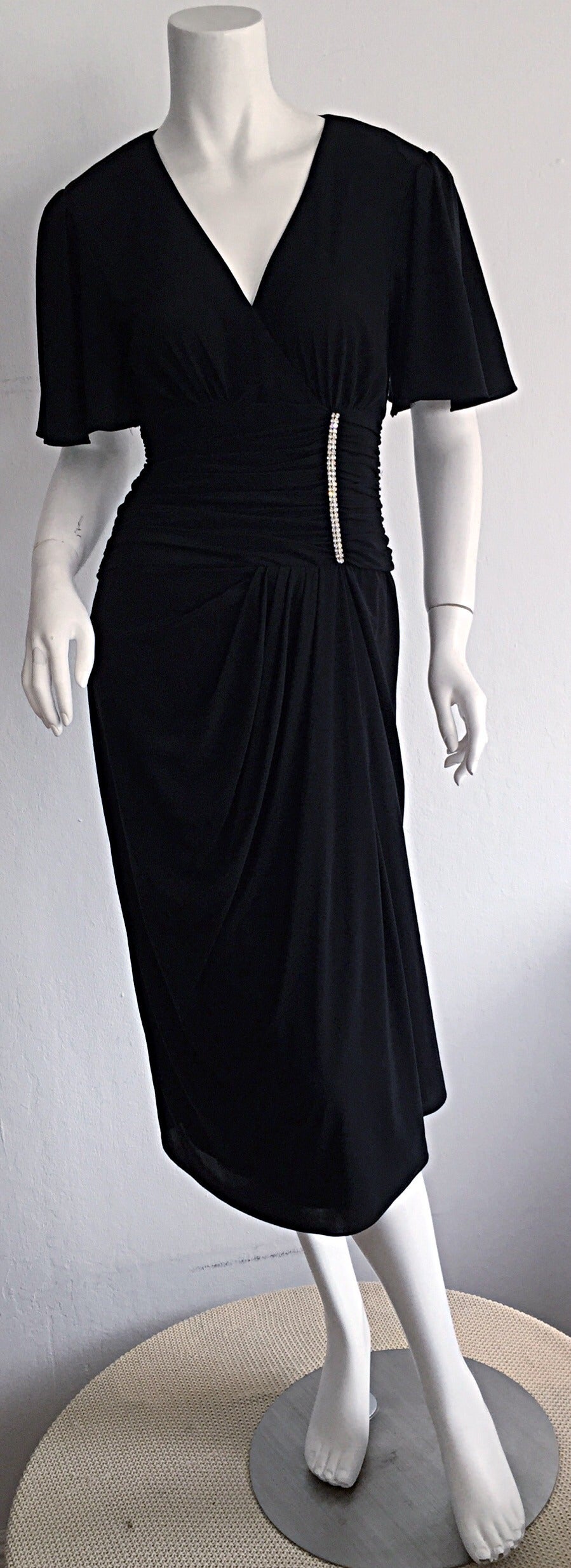 The BEST little black dress...EVER!!! This vintage Neiman Marcus beauty will surely get you through many emergency dress situations! Fitted bodice, with flutter sleeves, and gathering at waist, with rhinestones on one side. All leads into a