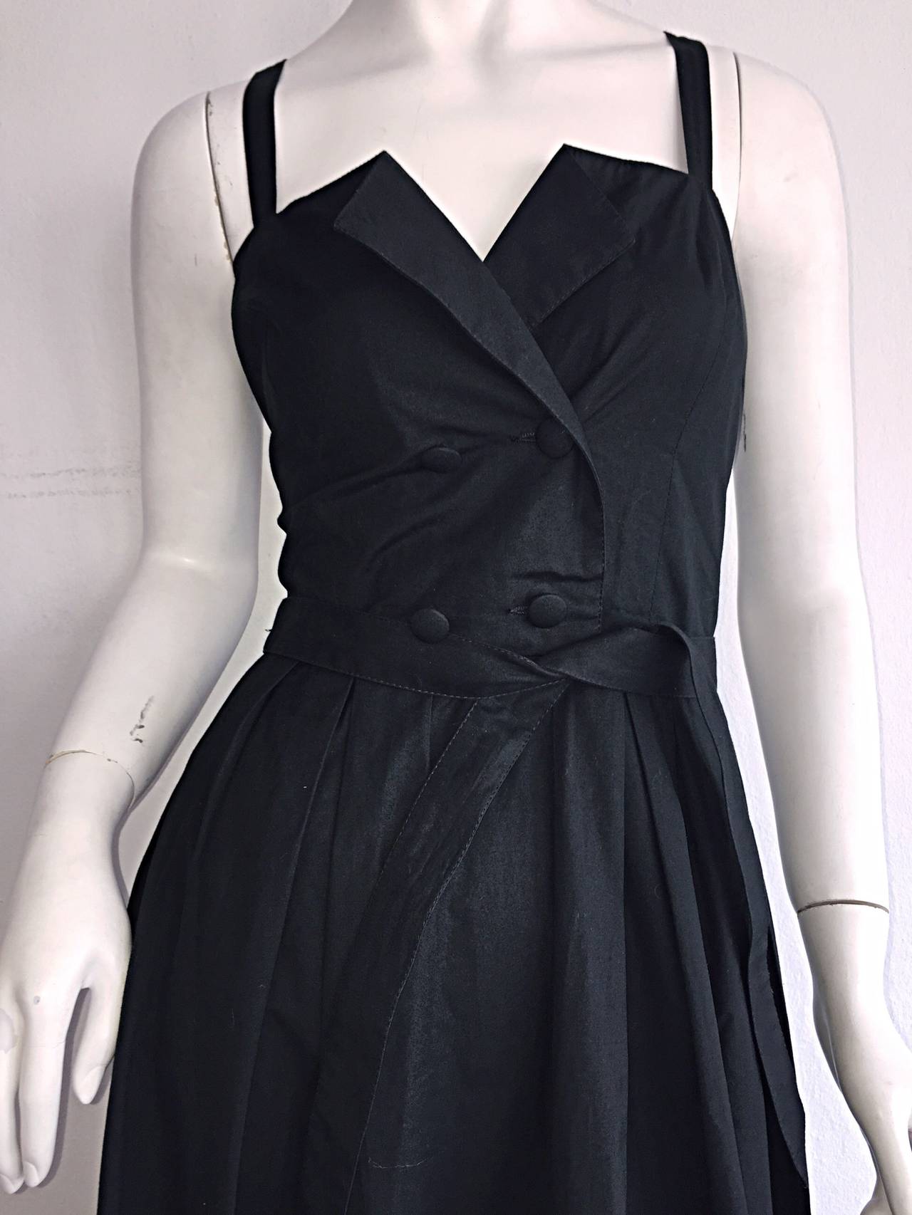 Beautiful vintage Emmanuelle Khanh black cotton sundress! Tuxedo-like style on bodice, with a double breasted closure. Features detachable tie belt, with the option of adding a personal 'statement' belt. Fantastic full skirt that looks fantastic