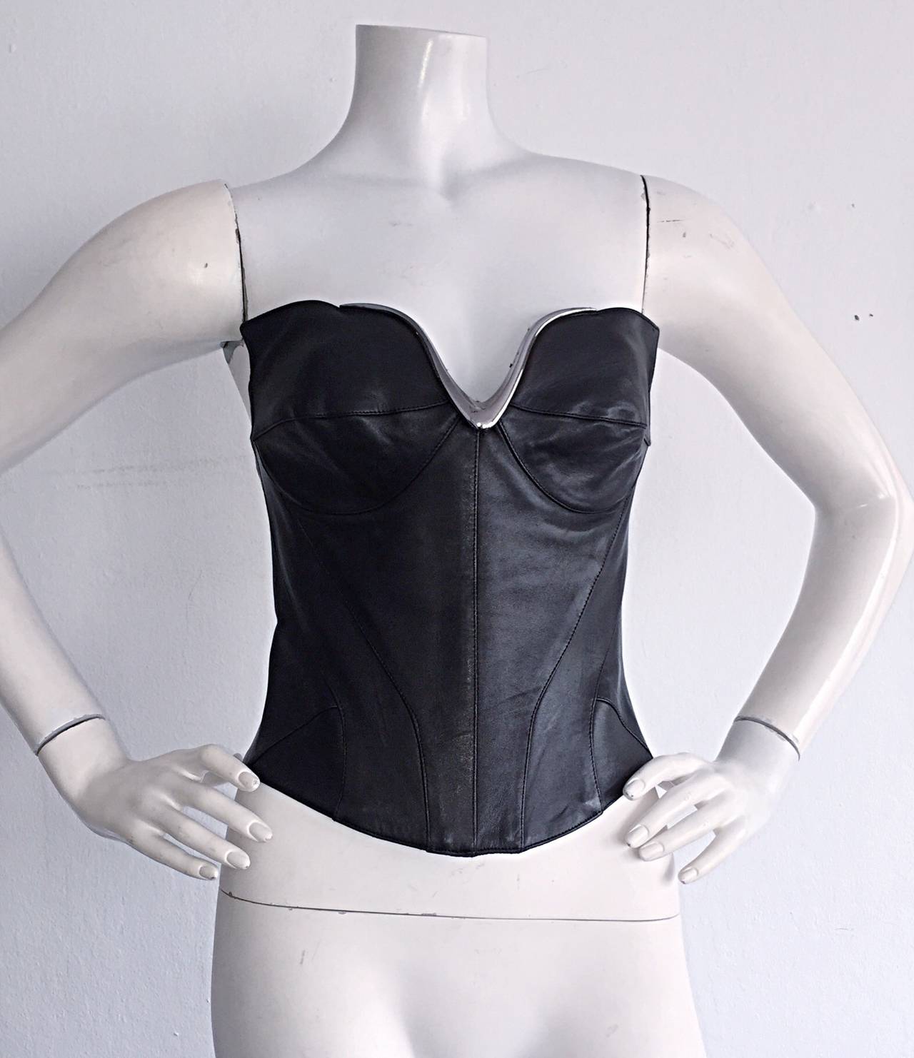 Rare vintage Thierry Mugler Couture black leather corset/bustier! Space-Age style. Butter-soft leather, with intricate stitching detail throughout. Gunmetal bust detail, with iconic wing details at side bust. Full leather, with two elastic bits on