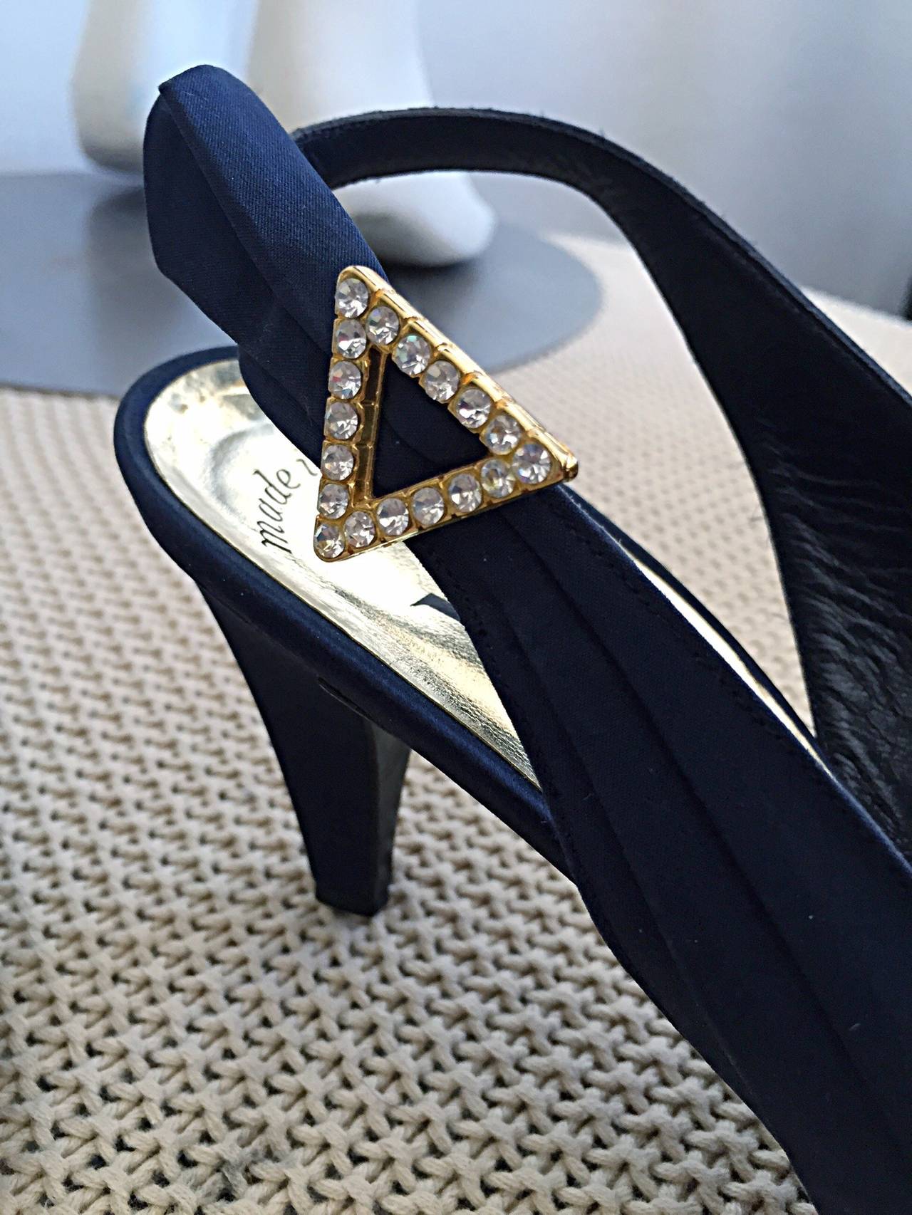 Beautiful vintage Yves Saint Laurent YSL navy blue heels! Avant Garde detailing, with 'wings' at each outer side. Triangle rhinestone detail that accents the 'wings.' Architectural slanted vamp that is very flattering. Absolutely stunning in person!