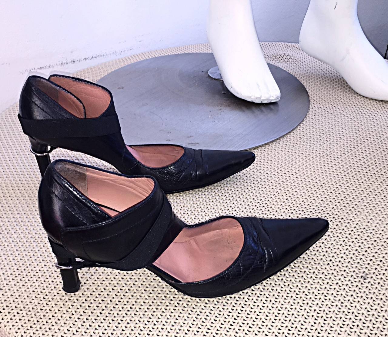 Rare Dirk Bikkembergs runway heels! Features a 'bondage' strap, with a loop that attaches to the heel. Sleek design, that can be worn with jeans, a dress, skirt, or suit! Made in Italy. In great condition. Minor wear from age. Marked Size 38 (US